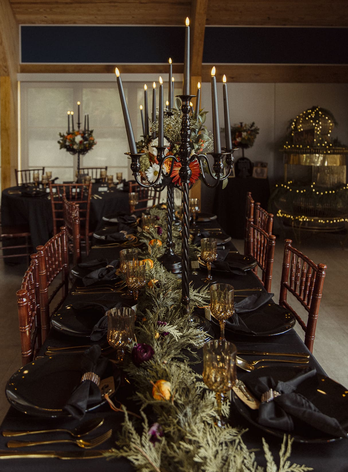 Luxury wedding reception table styled with black linens, gold accents, and candlelight, photographed in editorial fashion to inspire elevated wedding design. 