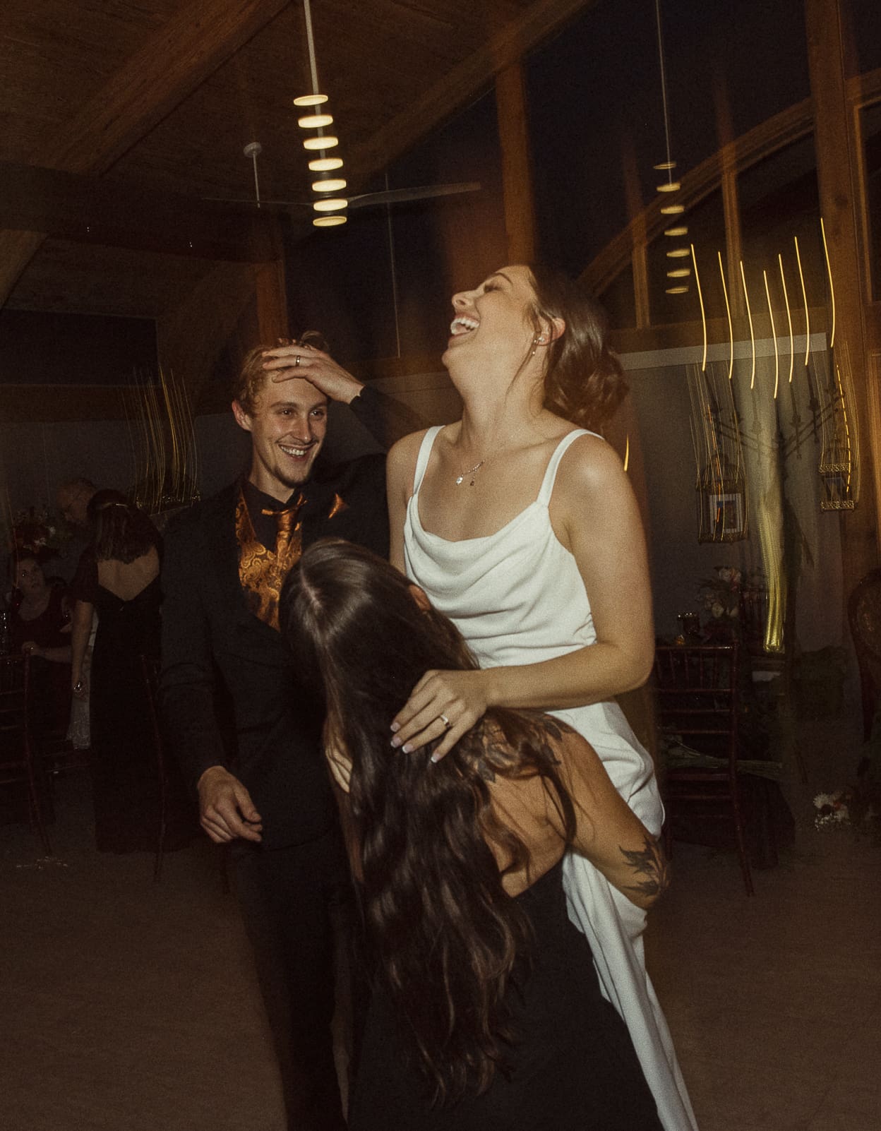 Joyful editorial wedding photo of a couple laughing together during their reception, highlighting the unposed beauty of authentic connection. 
