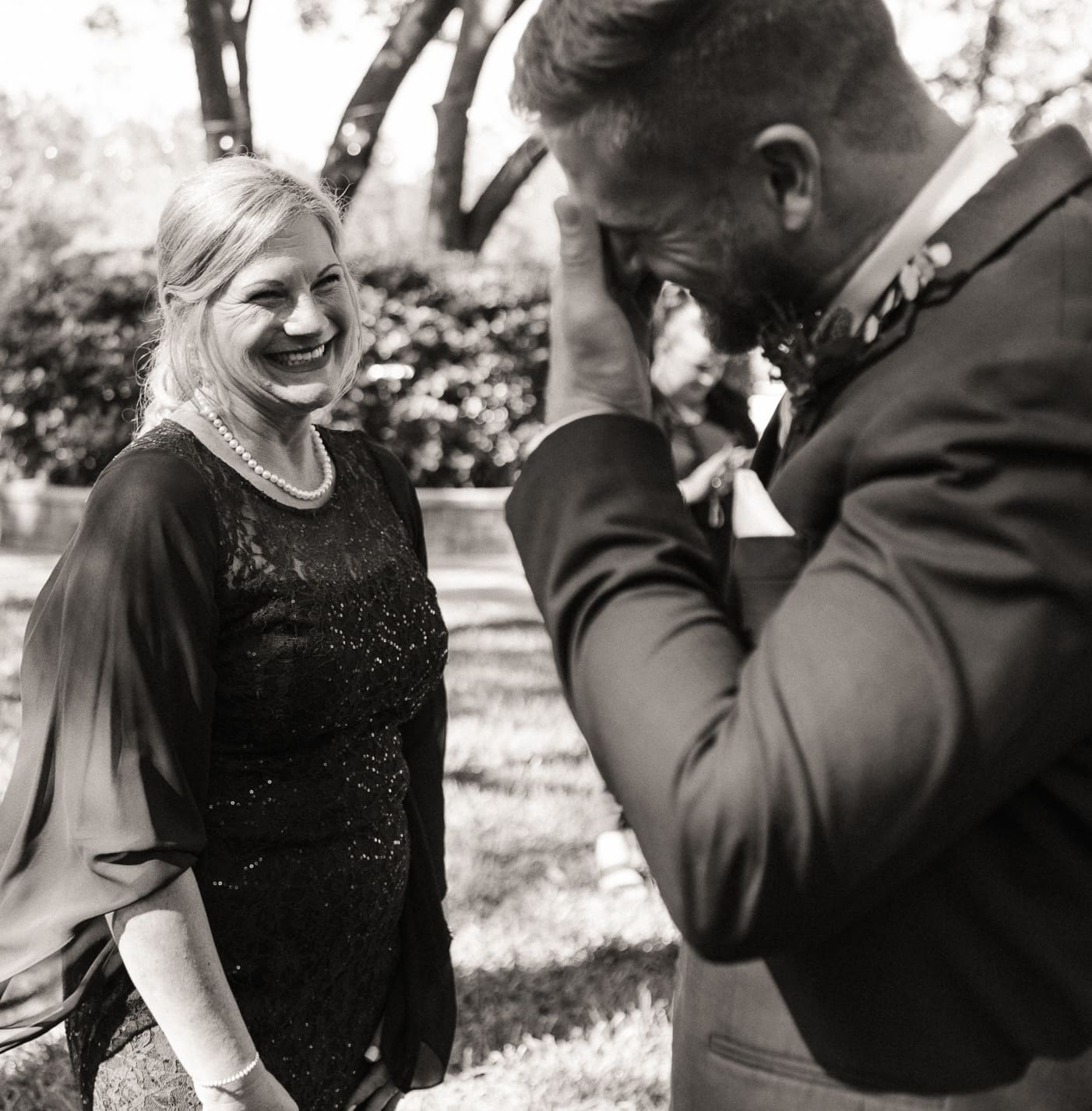 Emotional candid of two family members sharing a heartfelt moment, embodying the raw emotion behind effortless wedding storytelling. 