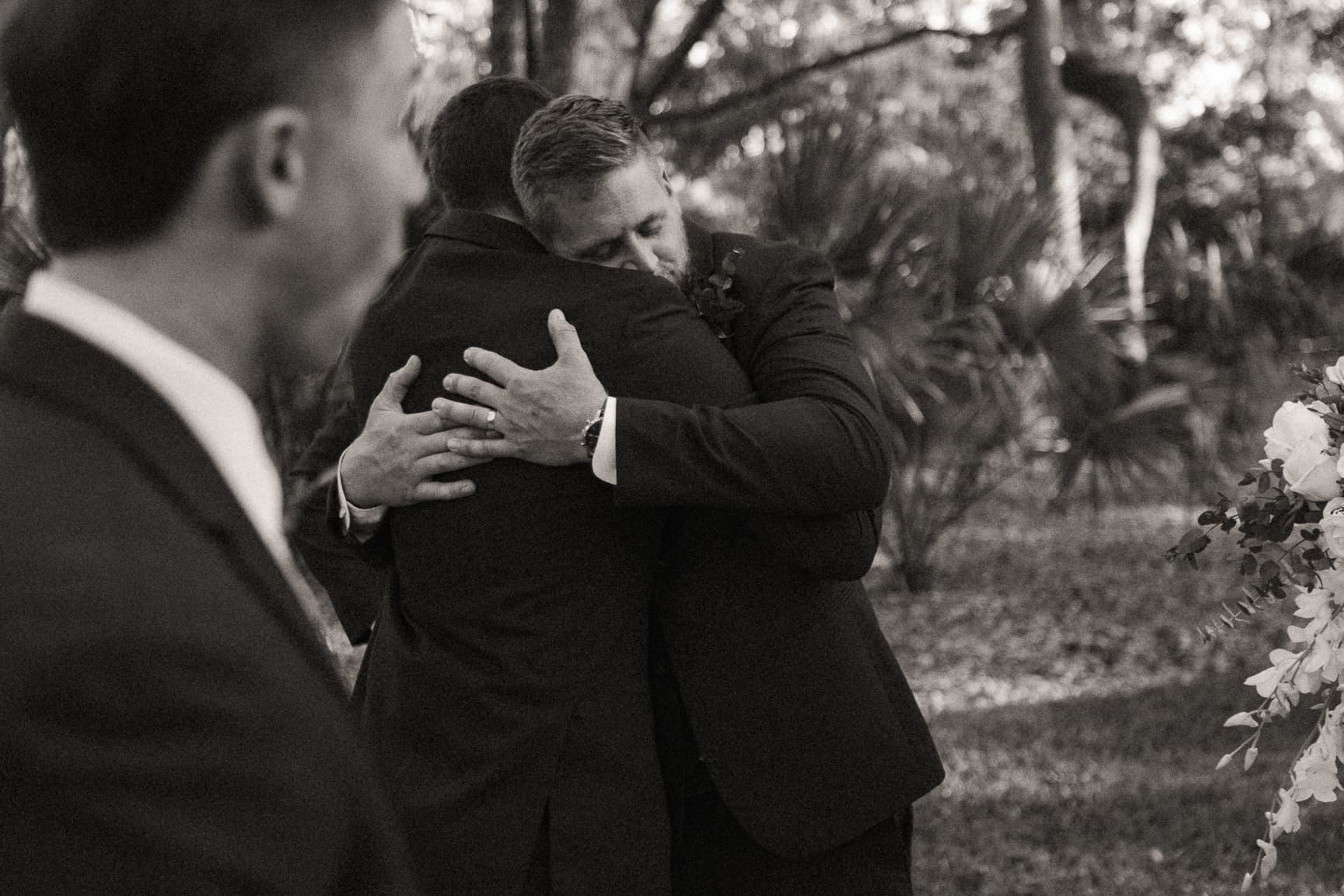 Emotional editorial wedding moment capturing an embrace between loved ones, reflecting the authentic connection behind fine art wedding photography. 