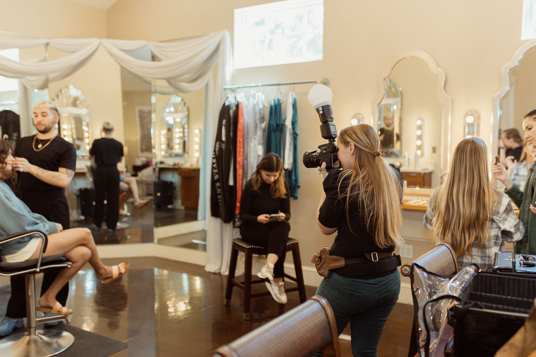 Behind-the-scenes image of a photographer documenting the getting-ready moments, showing the intentional direction behind effortless wedding photography. 