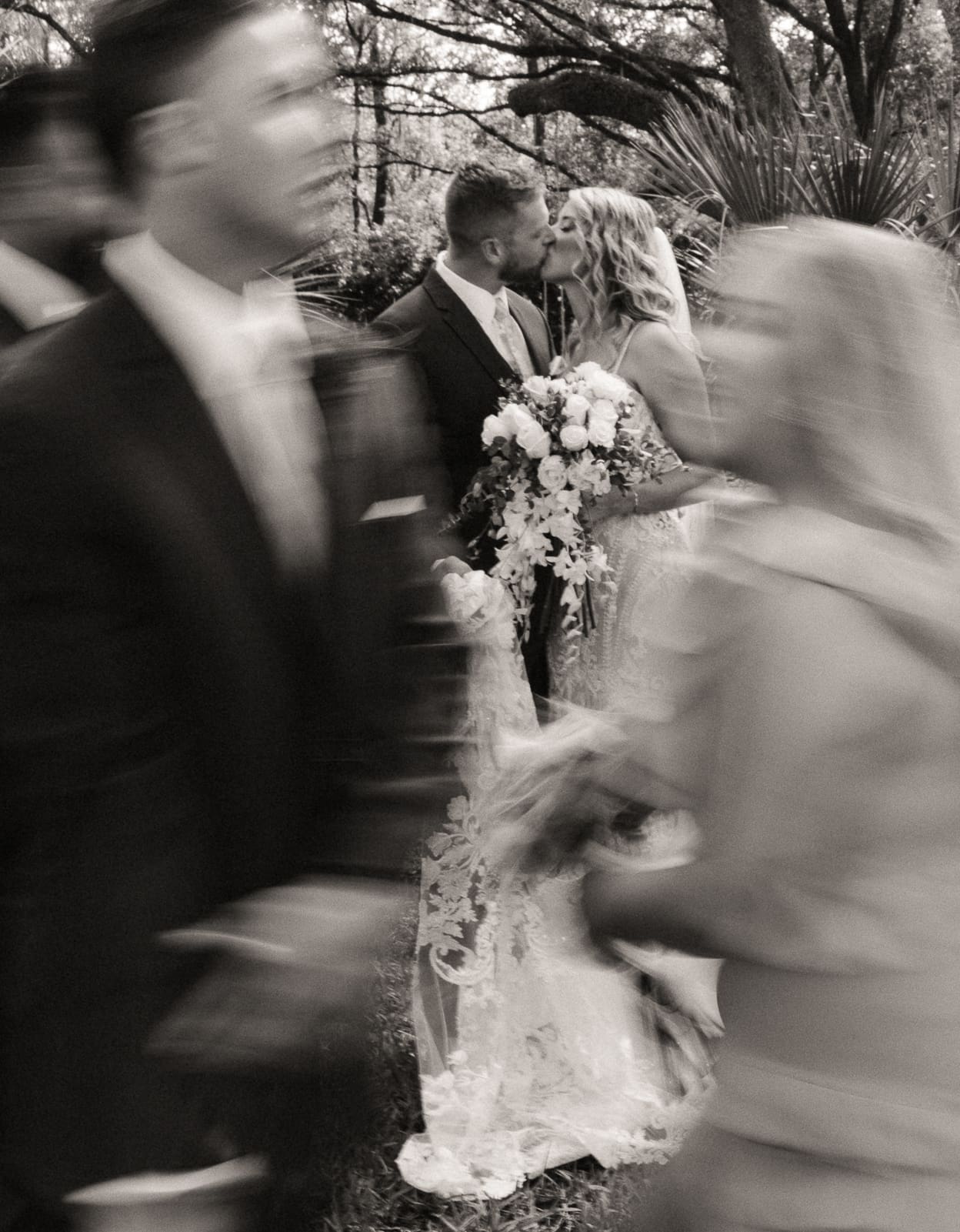 Black and white wedding photograph of a couple kissing with intentional motion blur, sowing how space in the timeline allows for artistic storytelling.
