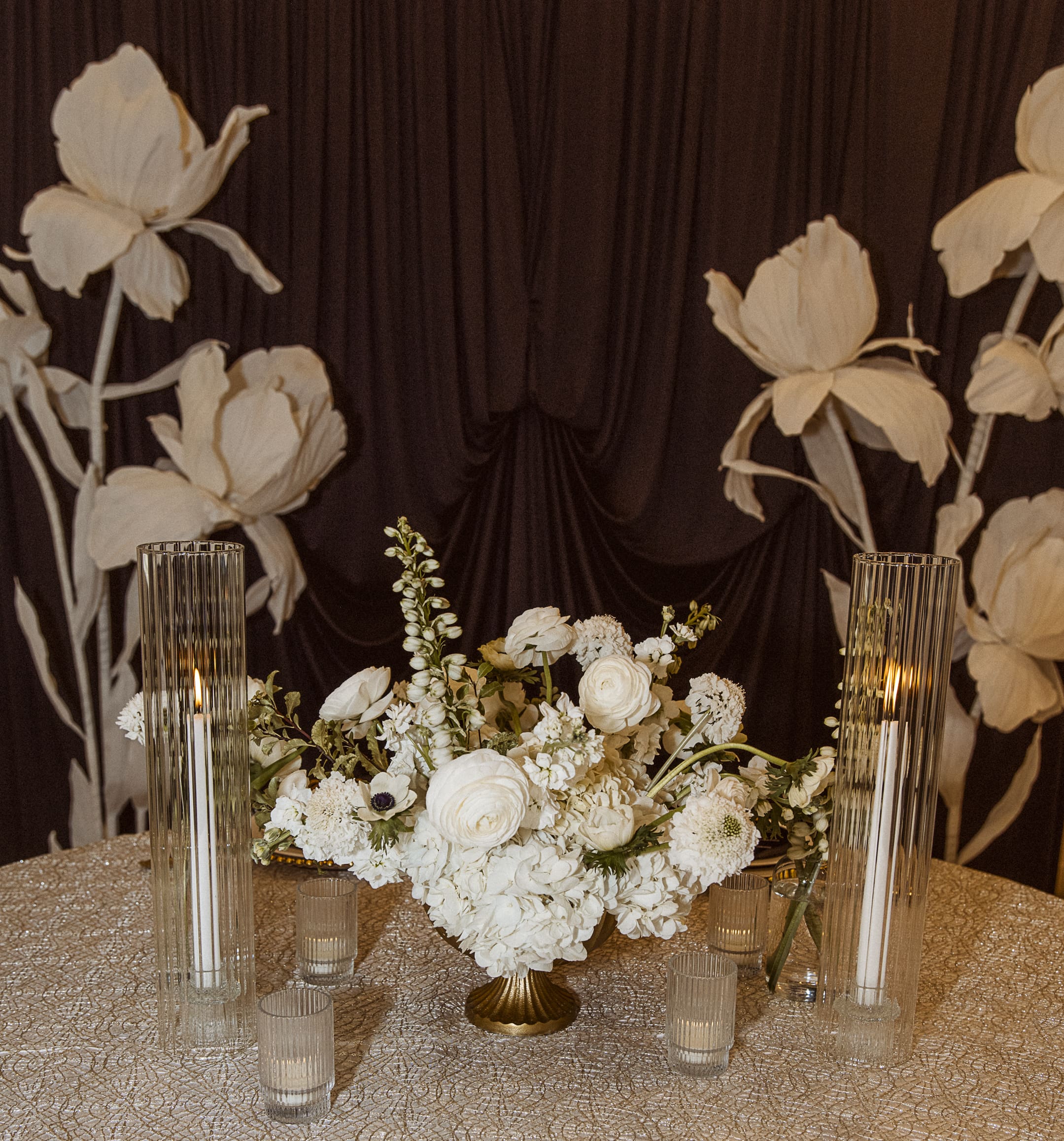 Floral centerpiece in a black, white, and gold tablescape design