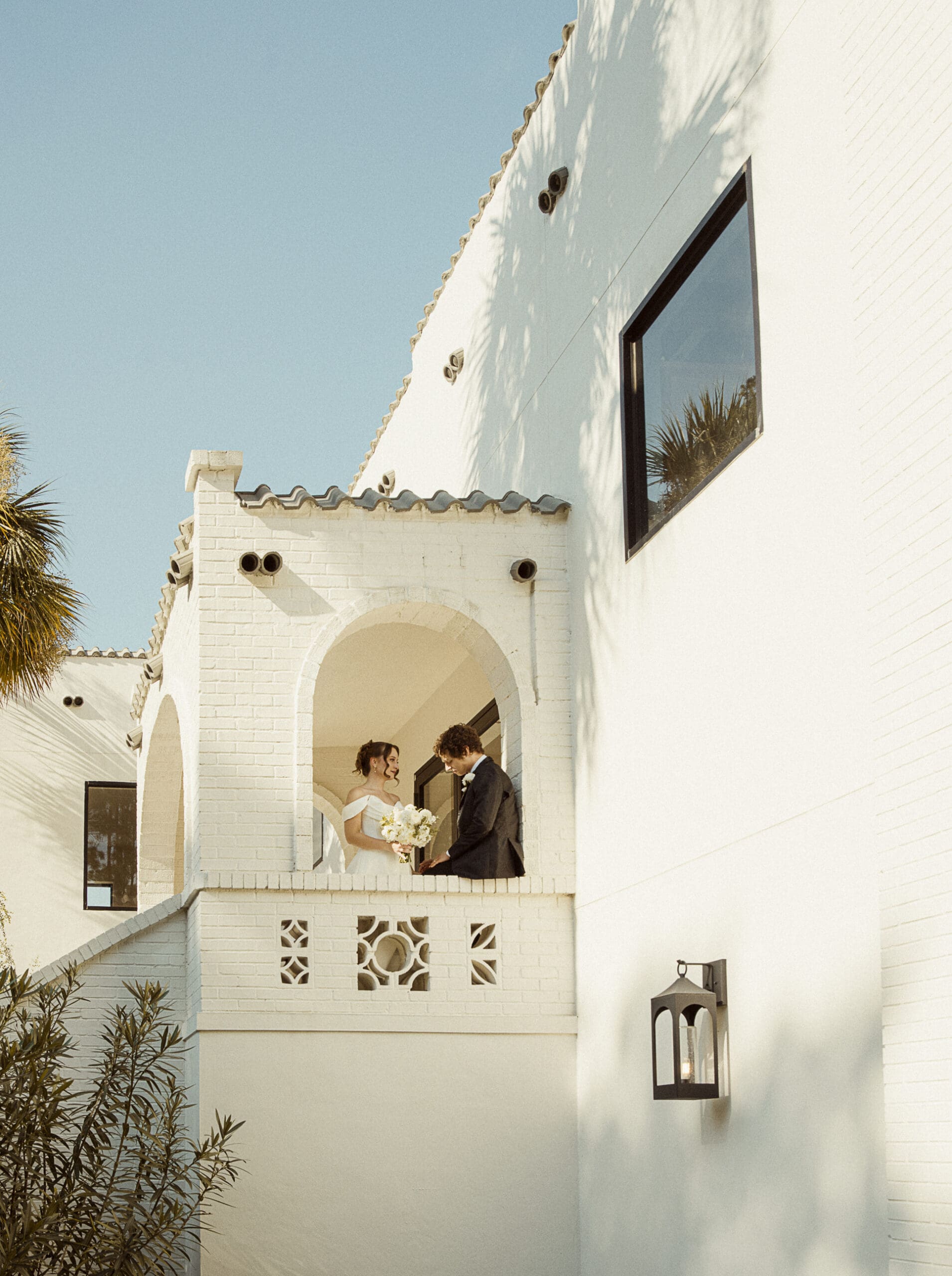Couple embracing on the wrought-iron balcony at the Old Spanish Quarter