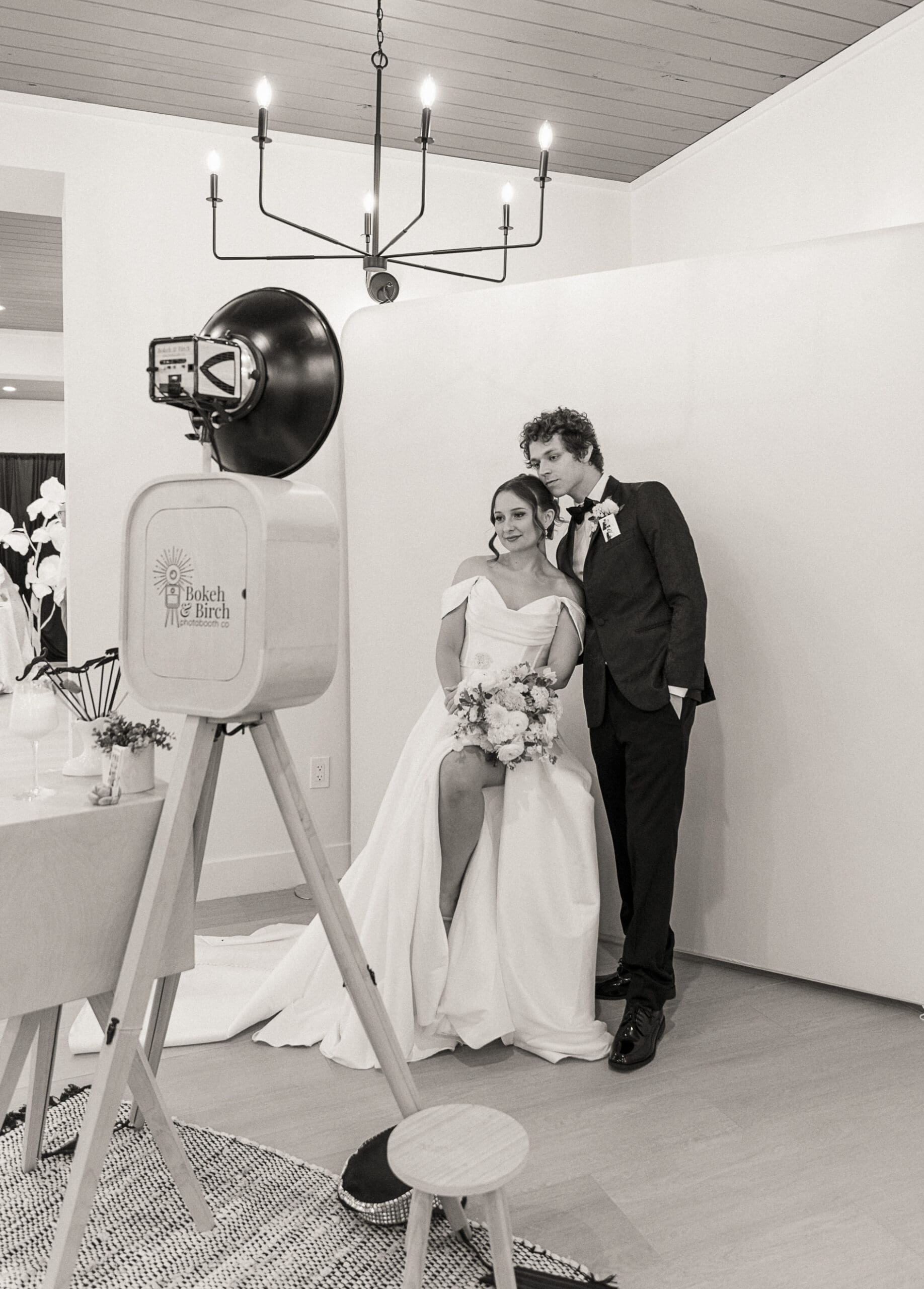 Bride and groom posing together at the Bokeh and Birch photo booth