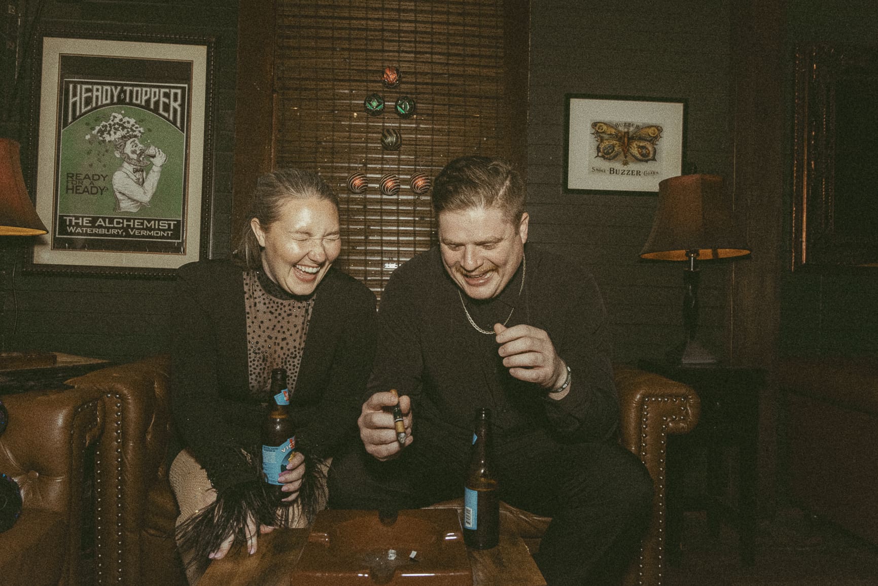 Candid engagement photography in St. Augustine showing a couple laughing together during a date night bar session.