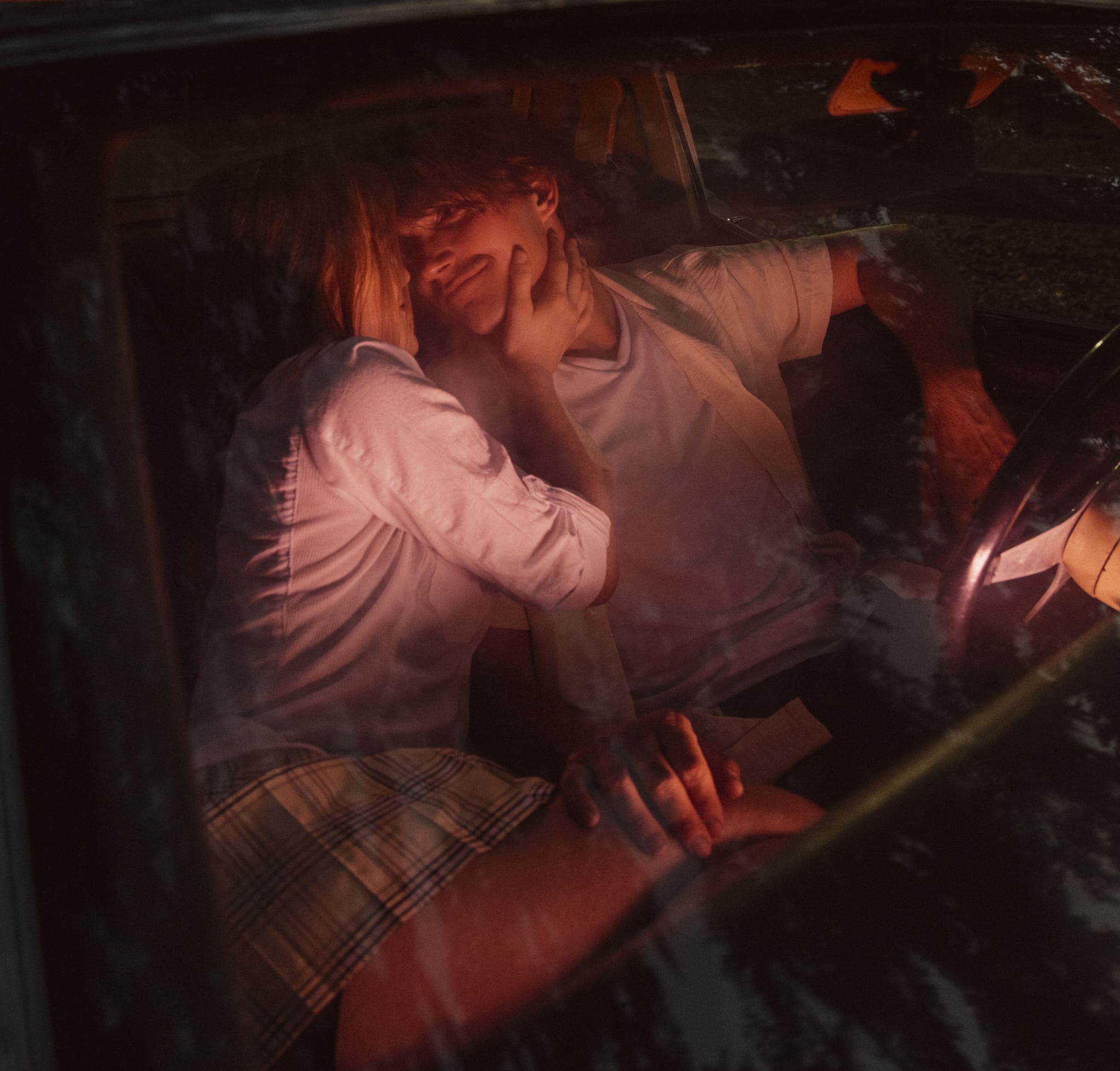 Intimate date night engagement session in ST. Augustine capturing a couple sharing a quiet moment inside a car at night. 