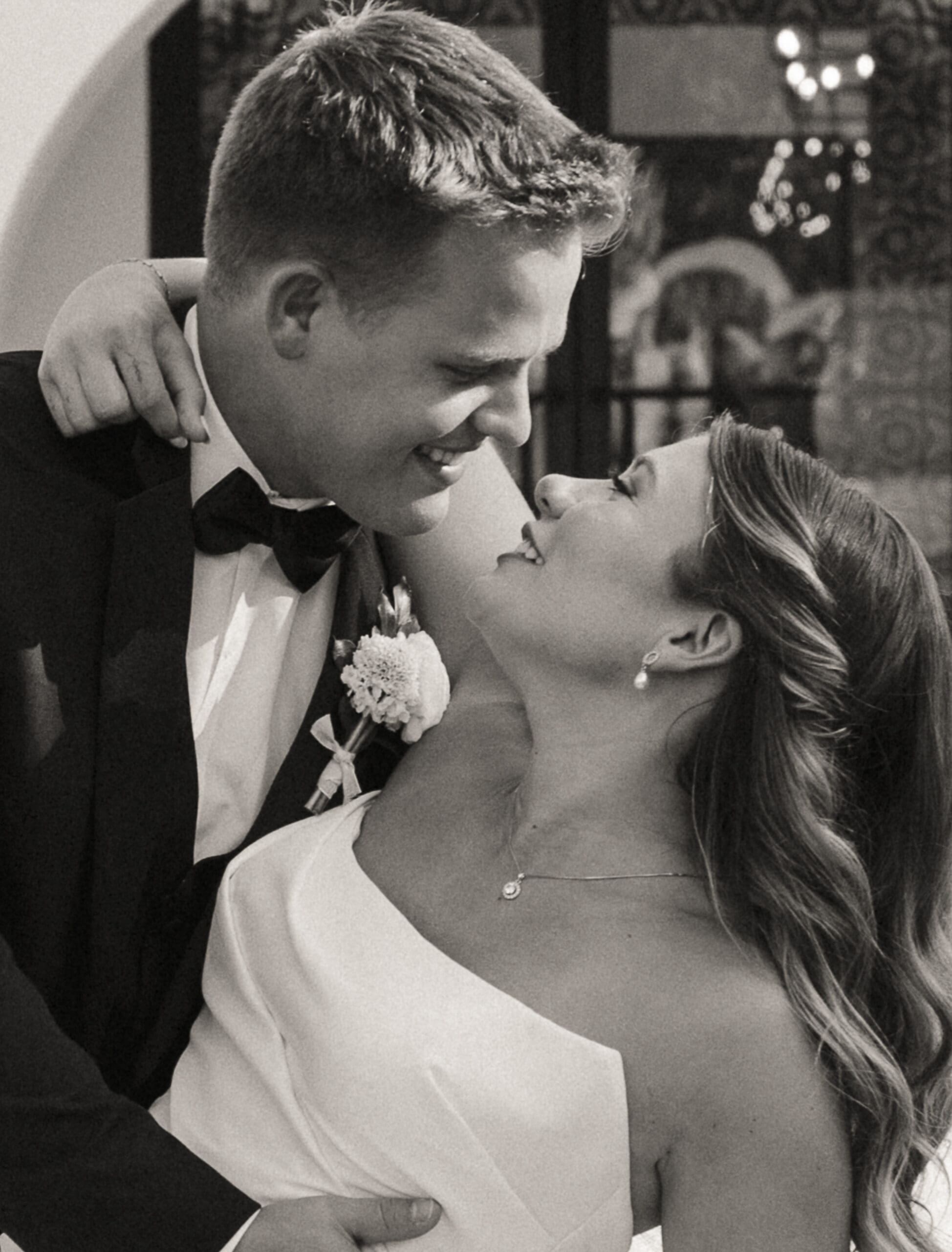 Bride and groom smiling at each other closely after the ceremony, appearing relaxed, present, and emotionally connected