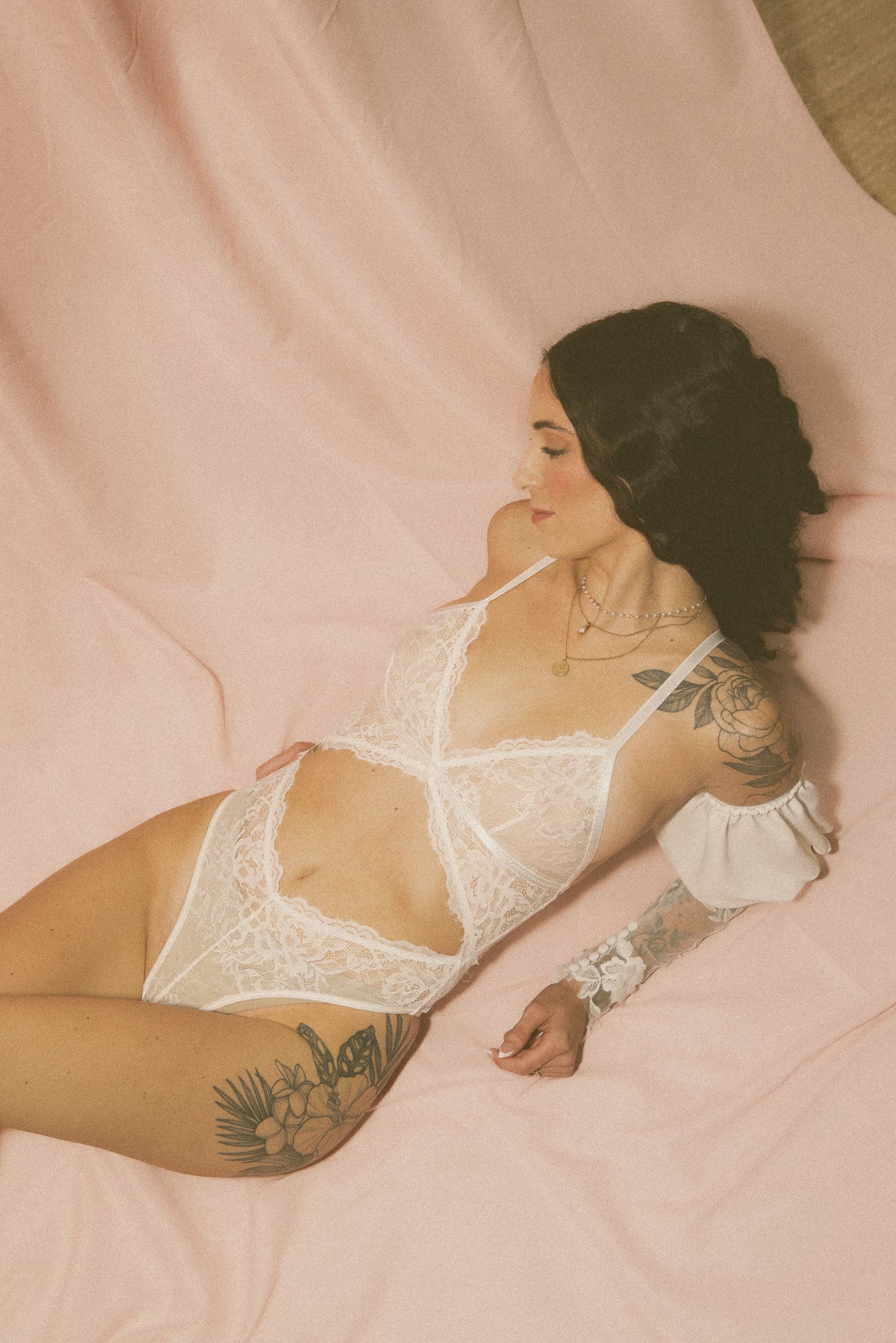 Woman reclining in white lingerie during a late-night embodiment photography session in St. Augustine