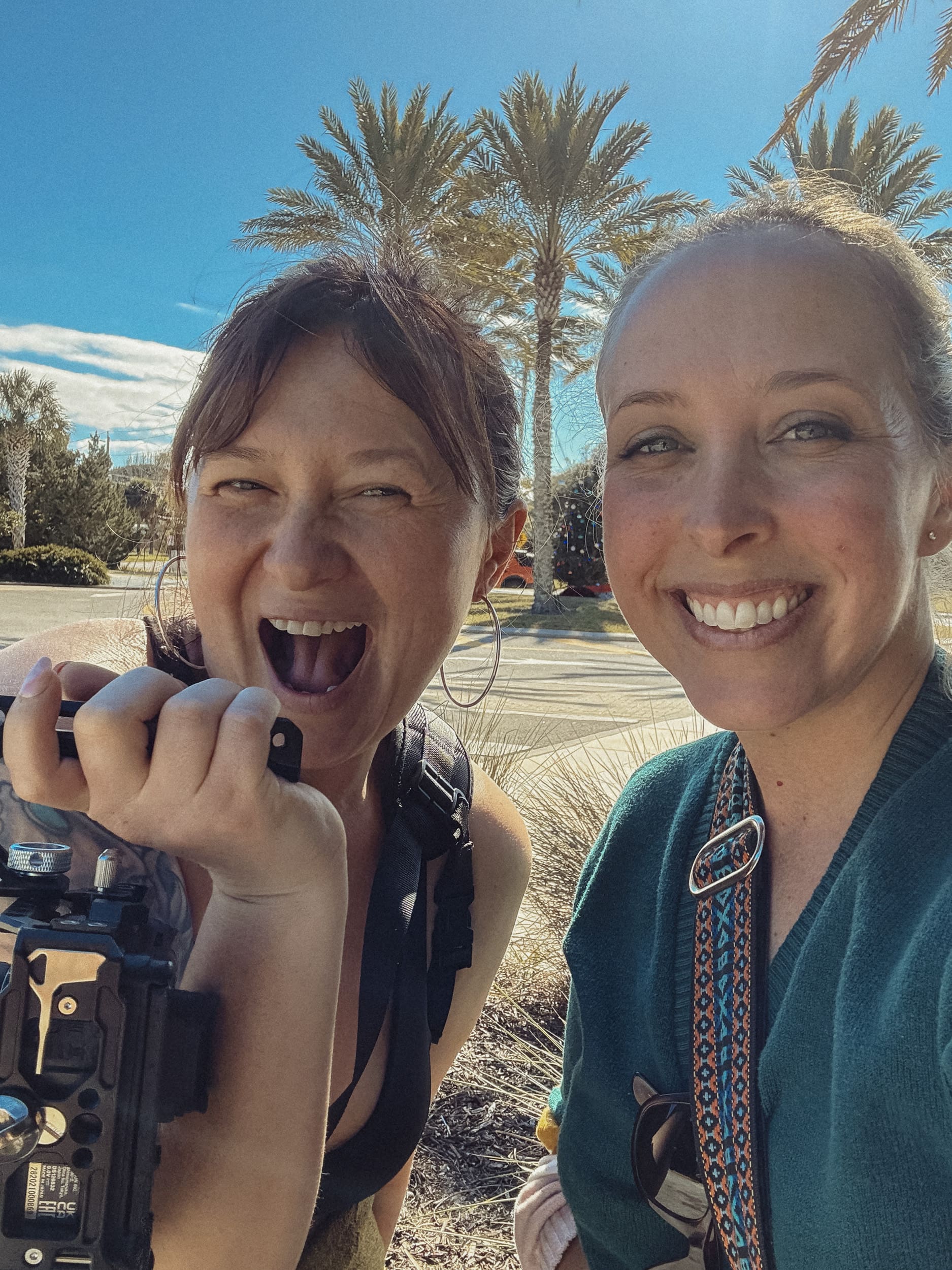Two photographers smiling together during a Creative Hours workshop, celebrating community and creative connection