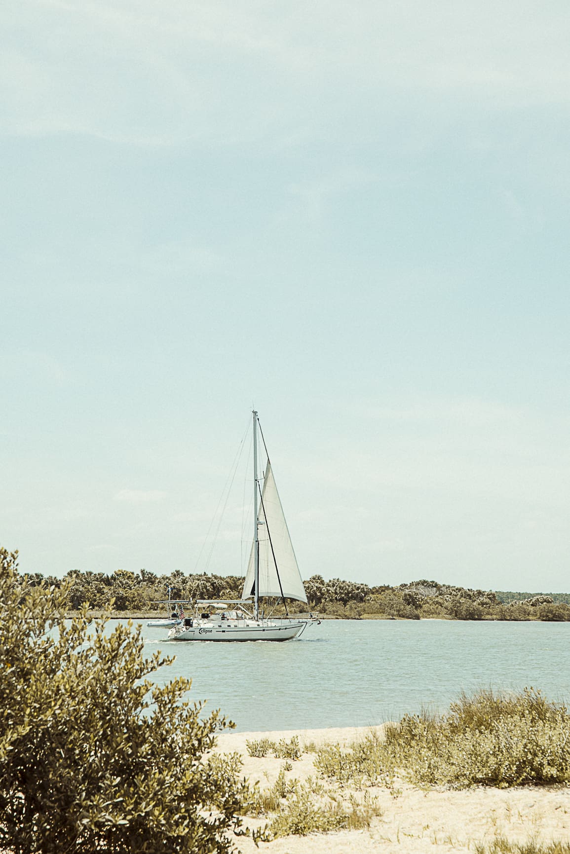 Sailboat floating along the Matanzas River near historic St. Augustine on a calm sunny day. 