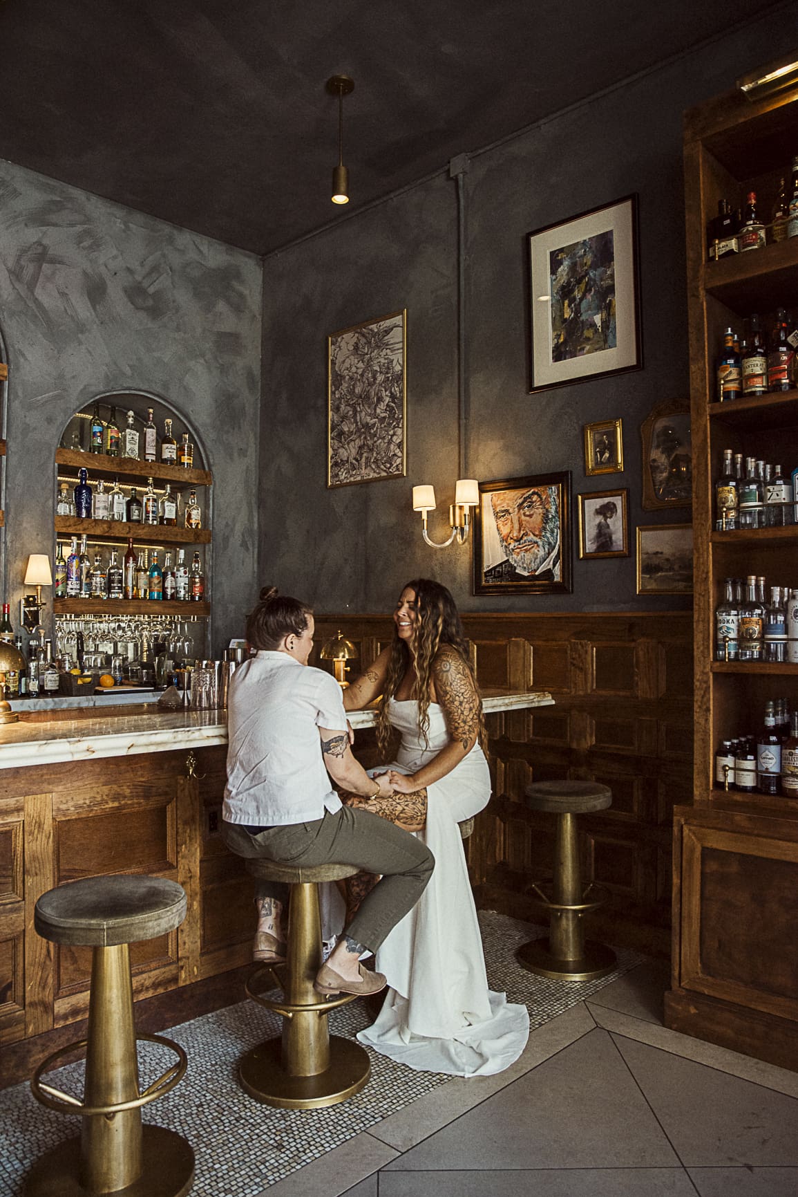 Couple sharing cocktails at an upscale bar in downtown St Augustine during an editorial wedding portrait session