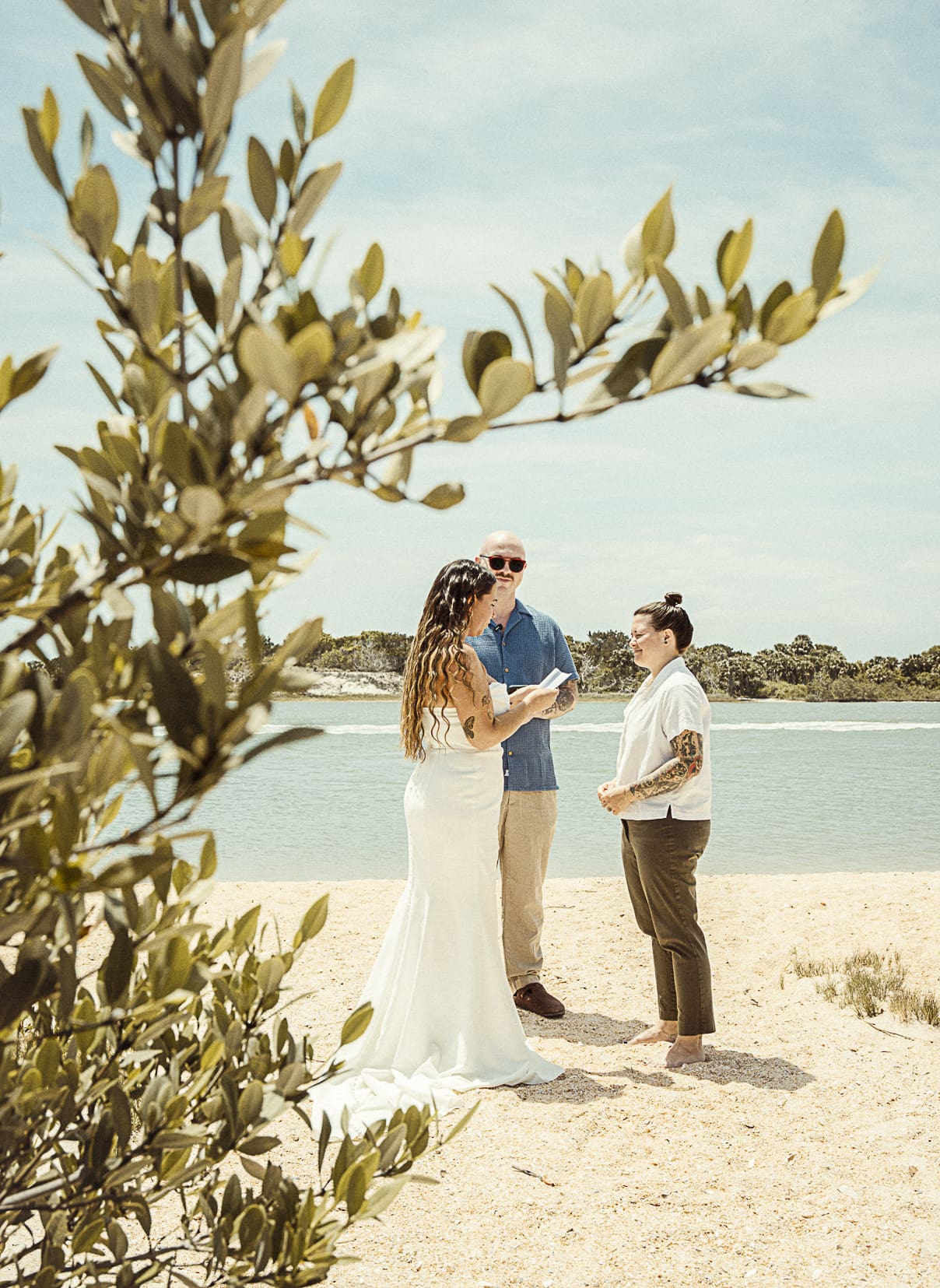 Intimate St. Augustine beach wedding ceremony with couple exchanging vows by the ocean.