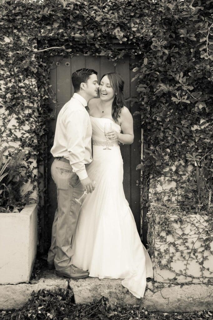 Bride and groom embracing in ivy covered doorway in historic St. Augustine Florida