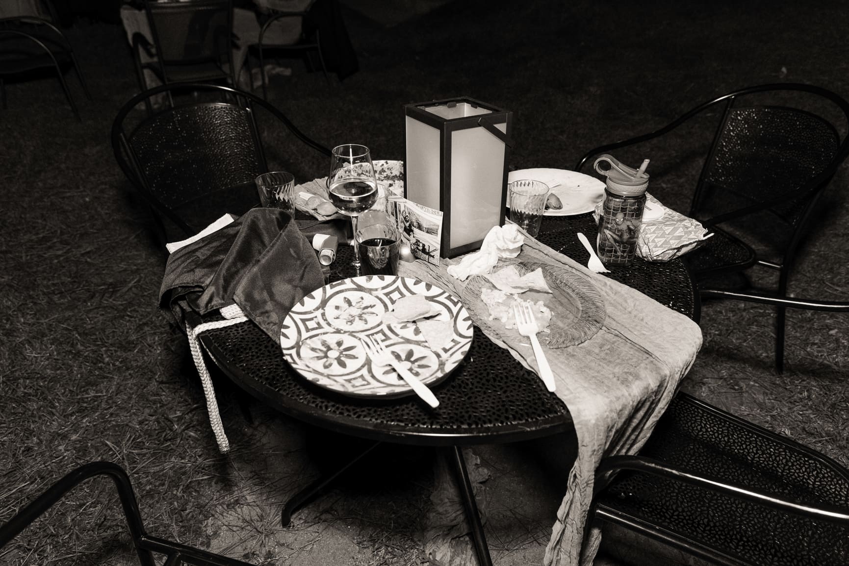 Intimate wedding reception table with wine glasses, plates, and candlelight at a non traditional St. Augustine wedding.