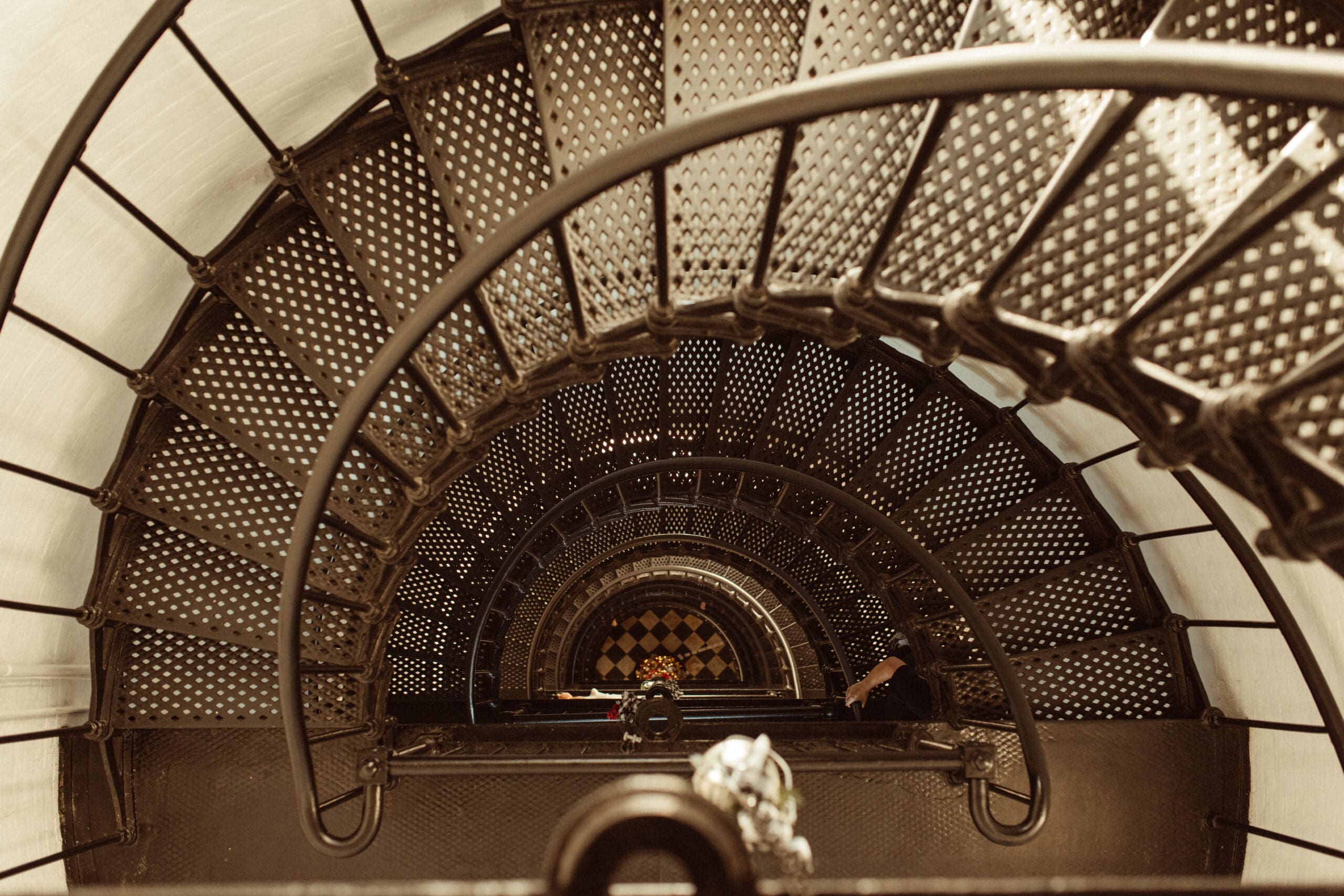Ornate spiral staircase inside historic St. Augustine Lighthouse, showcasing the city's timeless architecture and history. 
