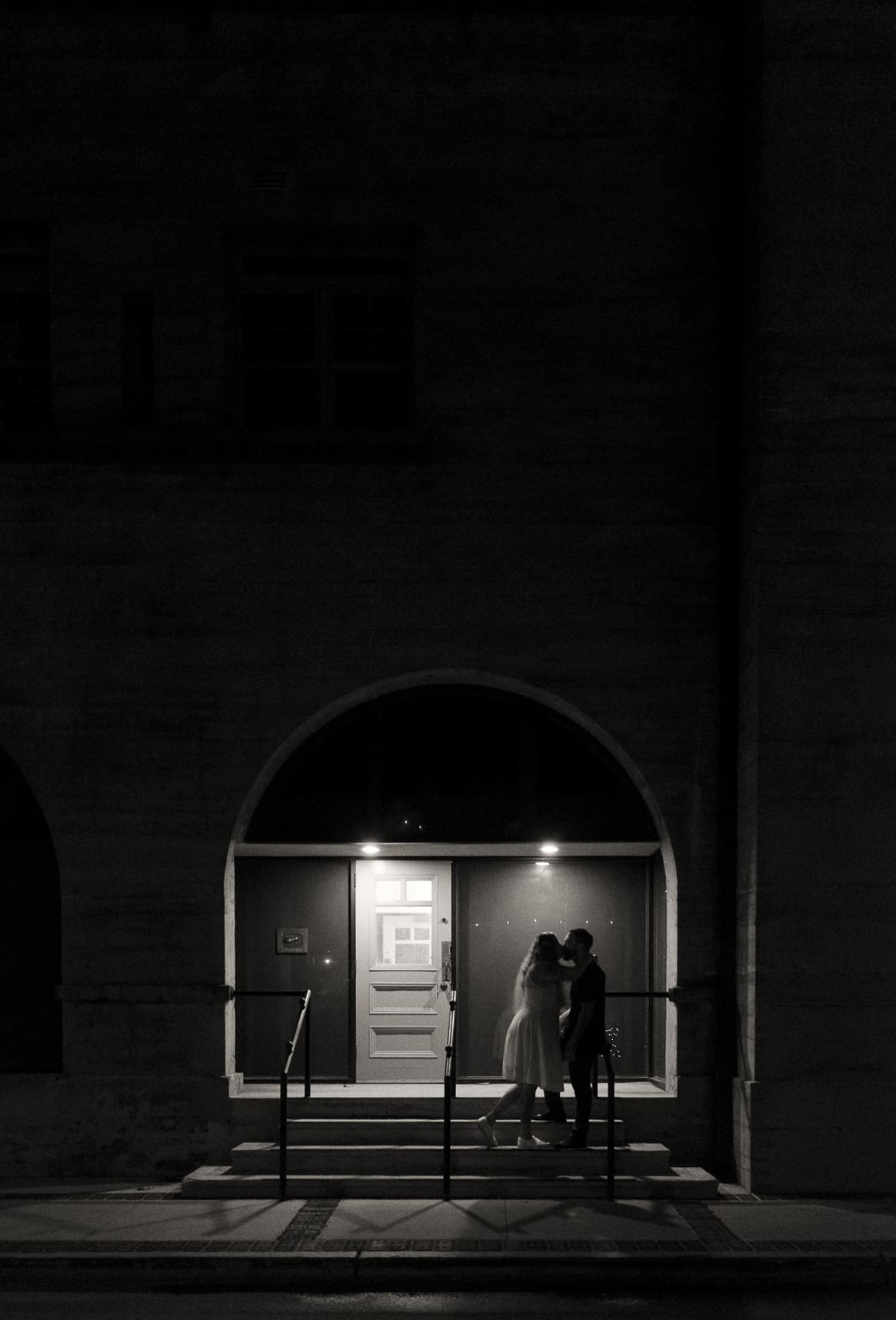 Couple silhouetted in historic archway in downtown St. Augustine Florida wedding portrait. 