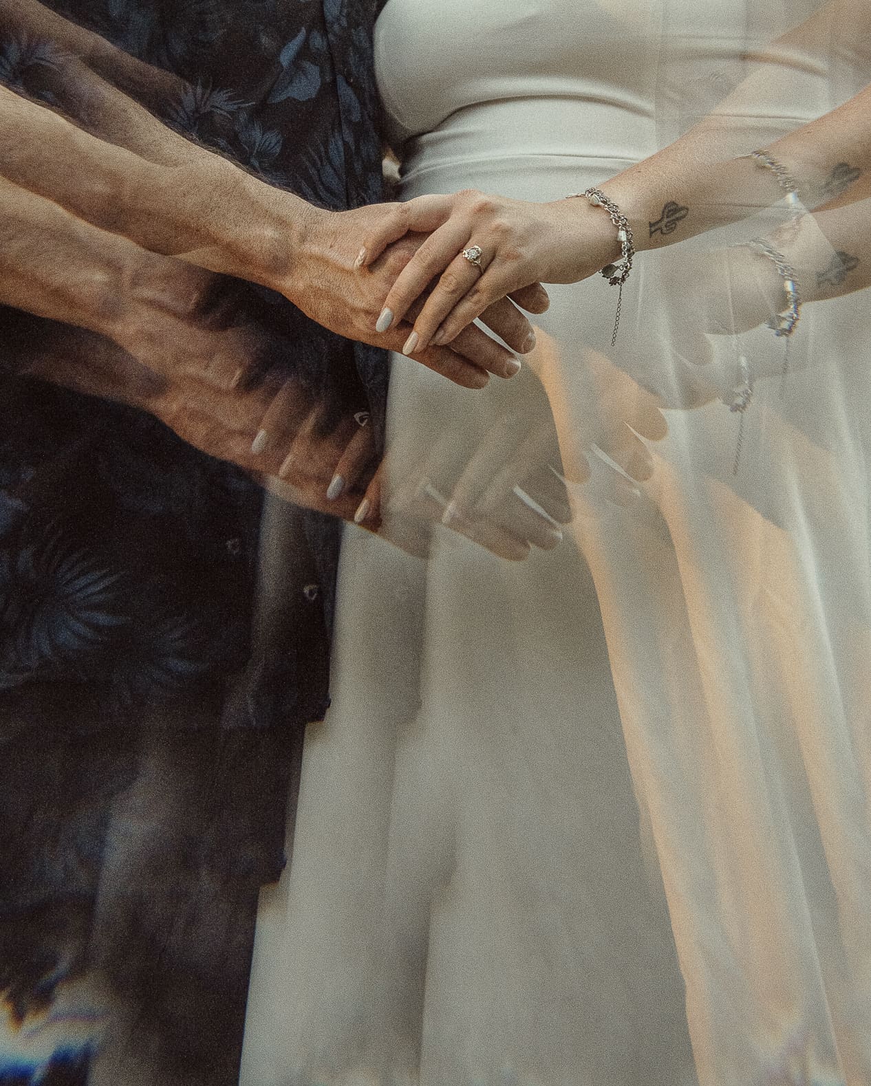 Close-up of couple holding hands showing wedding rings during an intimate St. Augustine wedding.