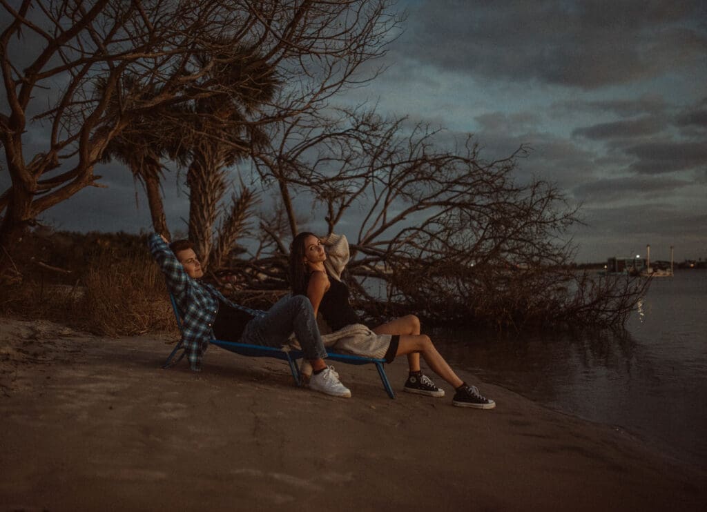 Couple sitting together near the beach during sunset in St Augustine Florida photographed by a St Augustine wedding photographer