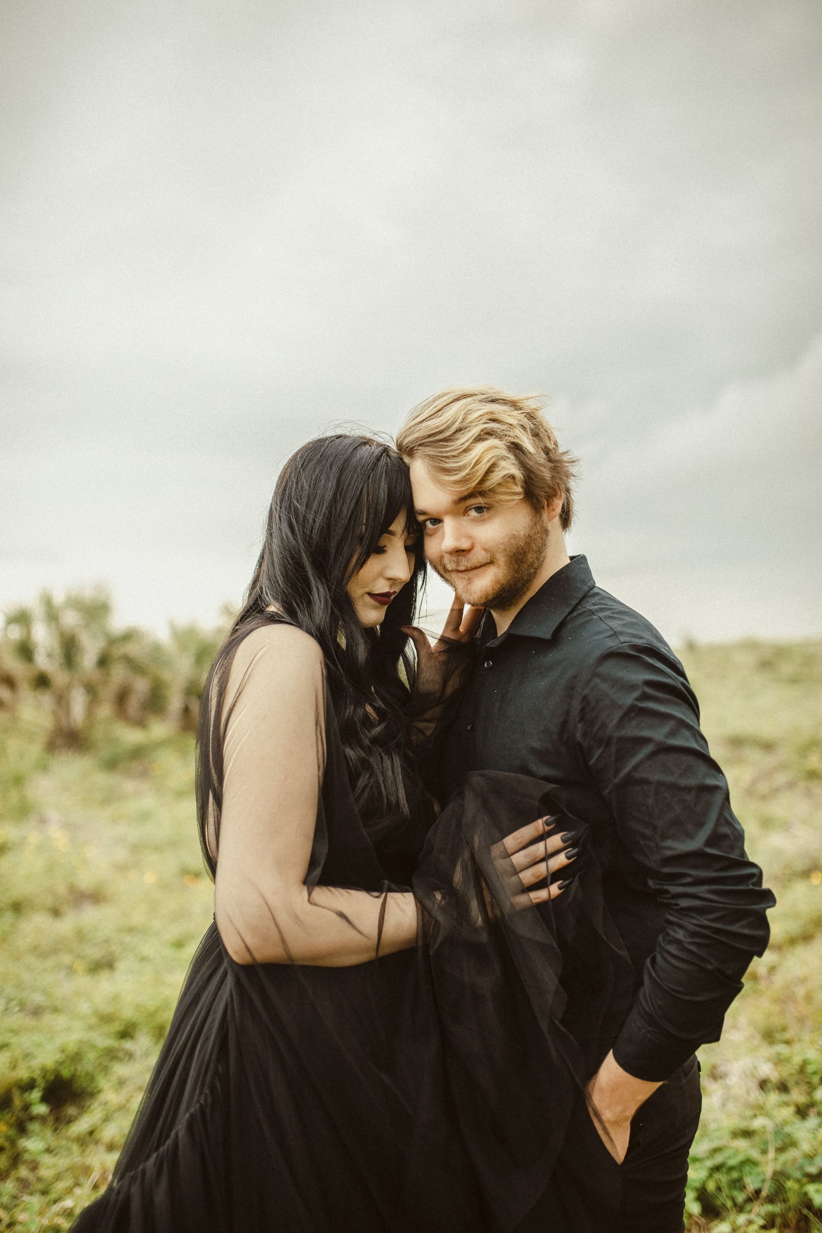 Editorial style wedding portrait of a coupe embracing outdoors during golden hour. 