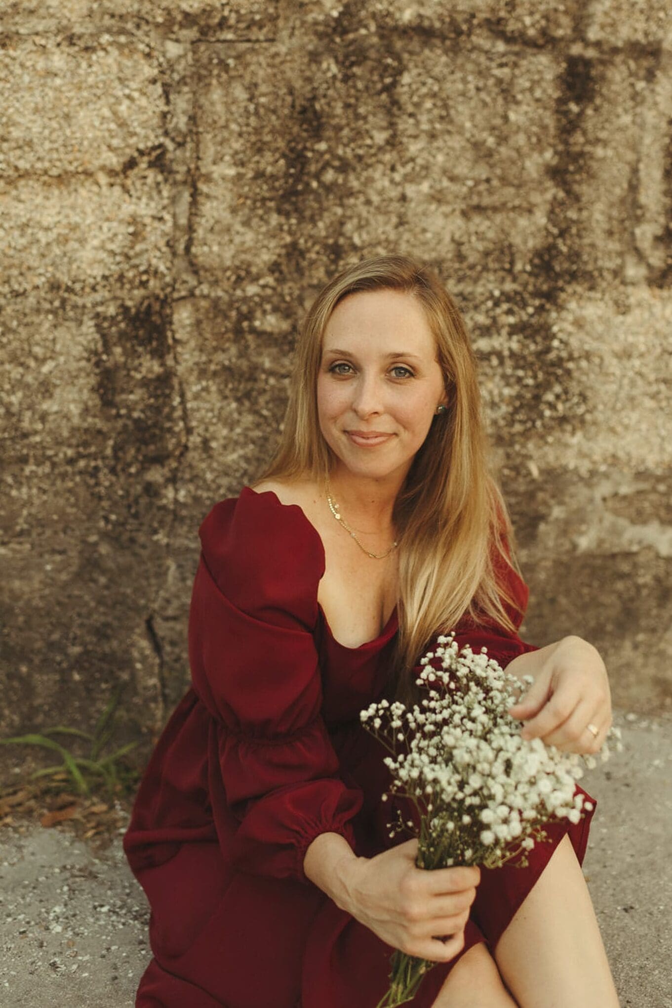 Portrait of St. Augustine photographer Brandi Denslow holding flowers, embodying a calm and grounded creative presence.
