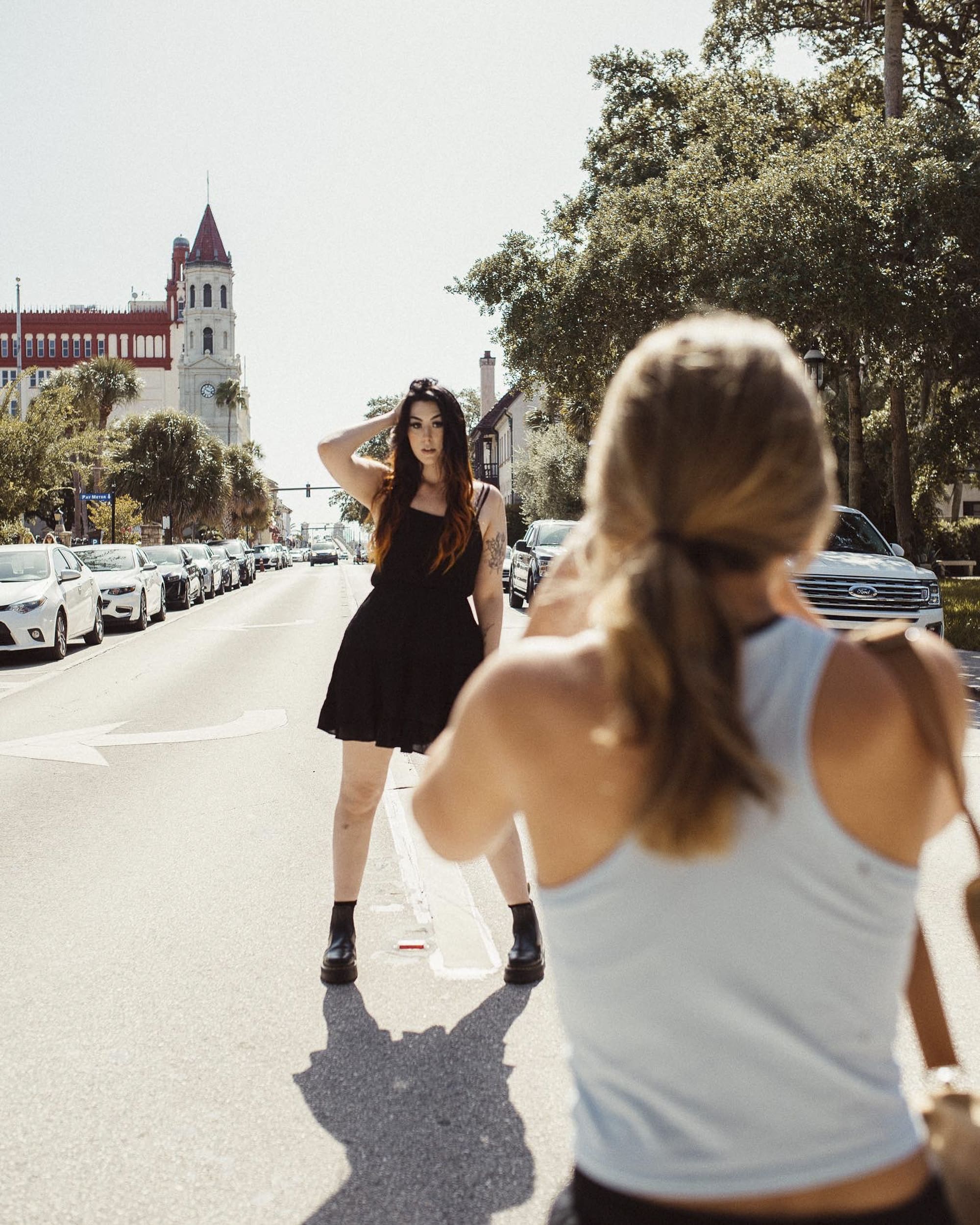 Behind-the-scenes moment of Brandi Denslow demonstrating creative shooting techniques while mentoring a photographer during an in-person session