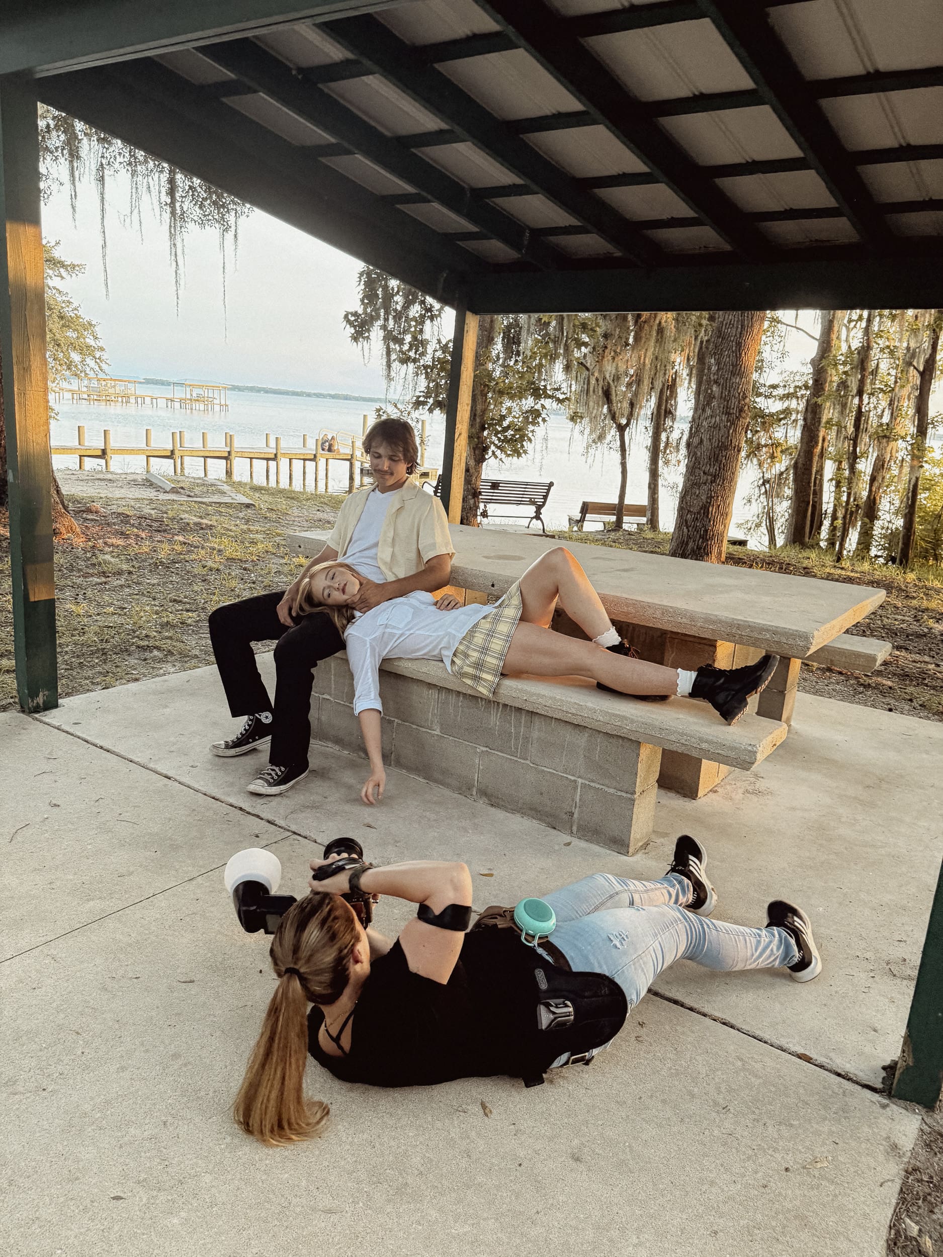 Behind-the-scenes moment of Brandi Denslow demonstrating creative shooting techniques while mentoring a photographer during an in-person session