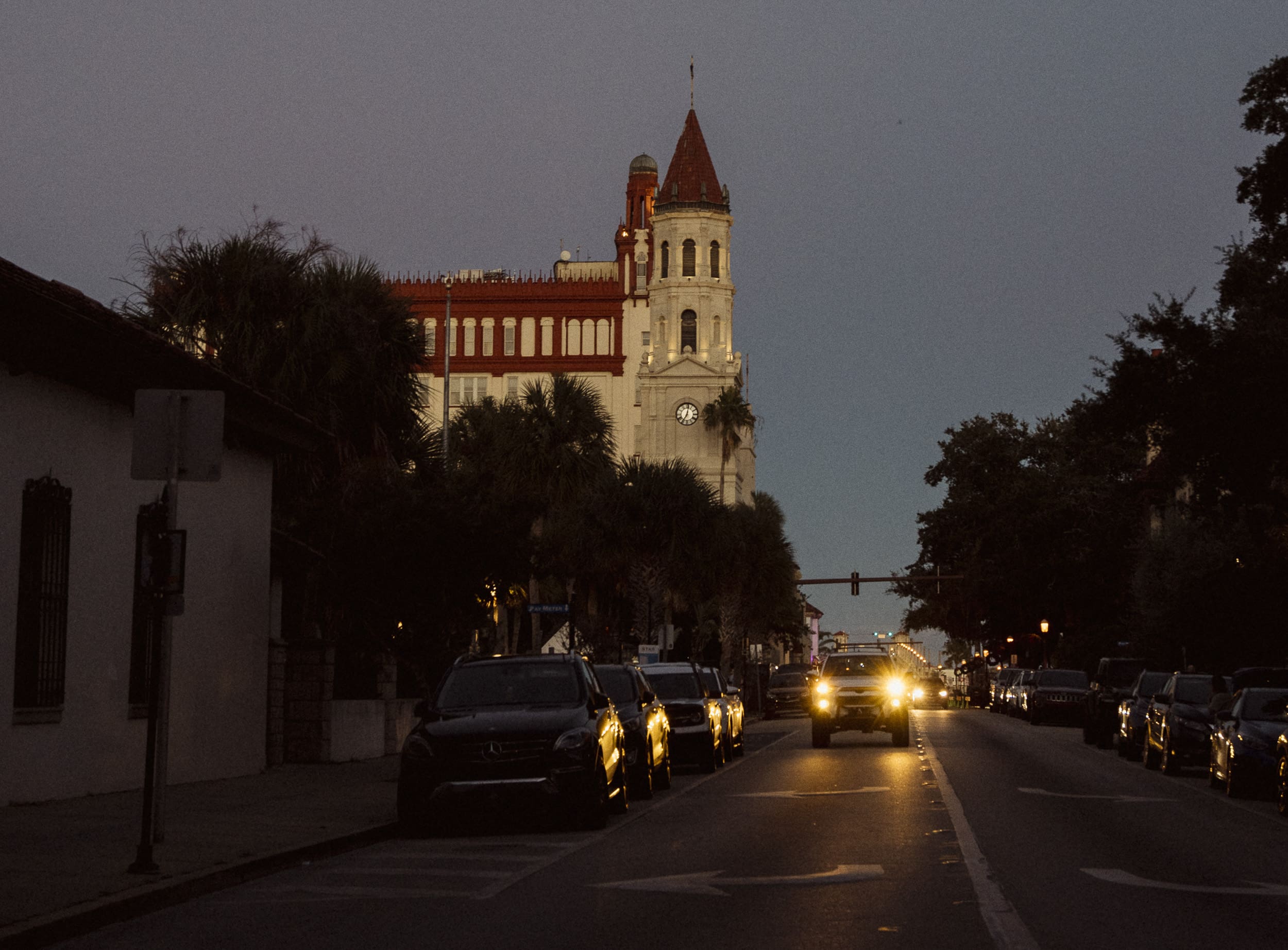 Downtown St. Augustine street photographed at dusk with headlights and historic buildings during a photo walk