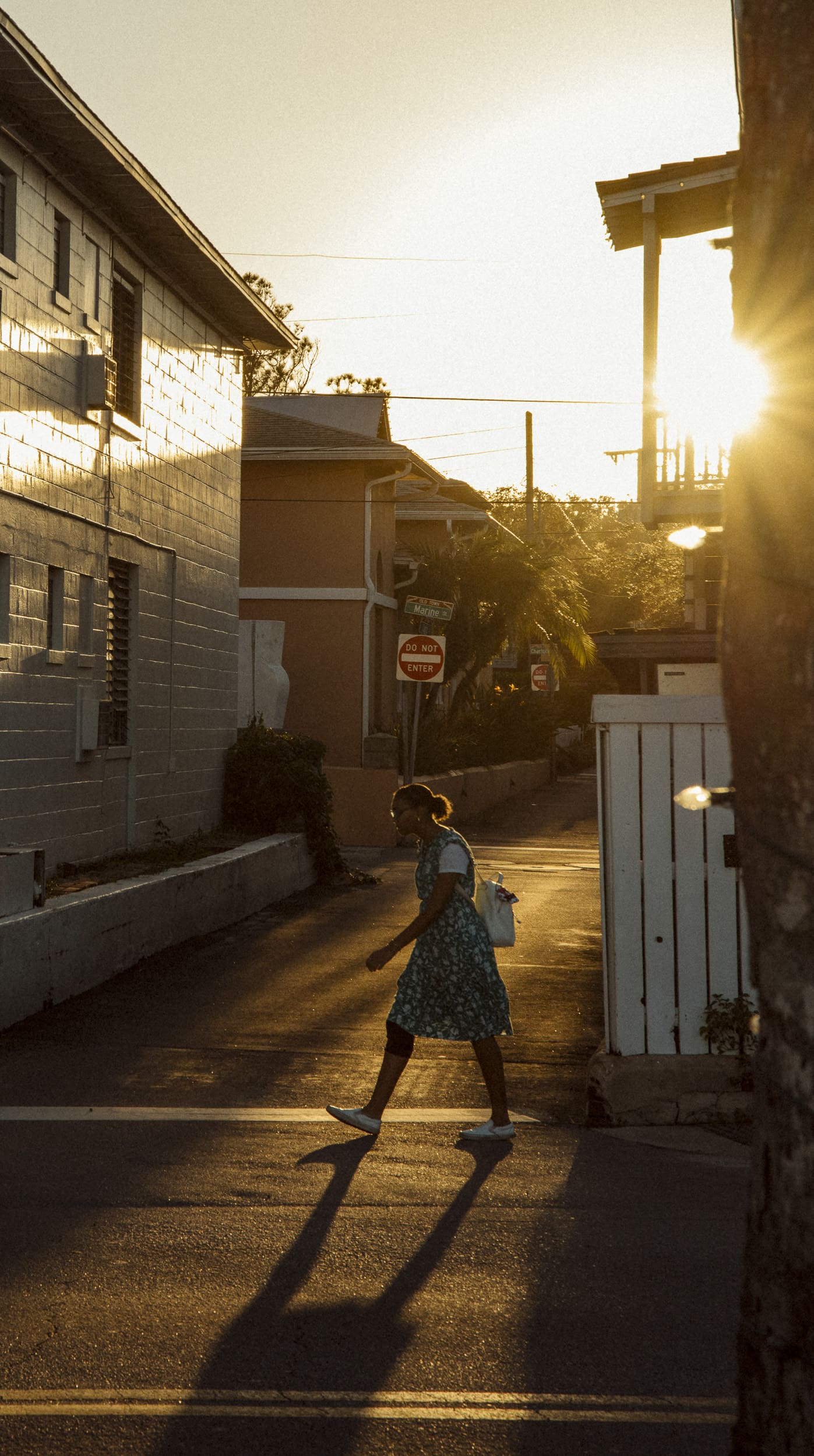 Woman walking through downtown St. Augustine at golden hour during a photography photo walk