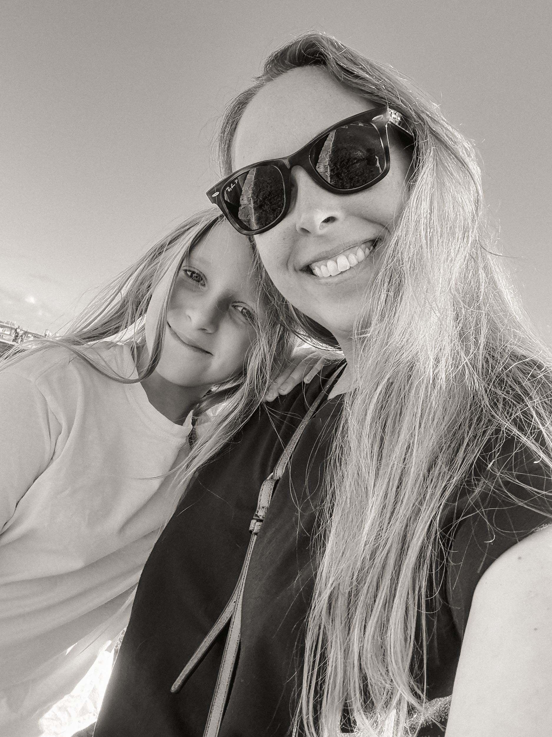 Mother and daughter smiling together during a downtown St. Augustine photo walk, captured in a black and white self-portrait taken by the photographer’s daughter.