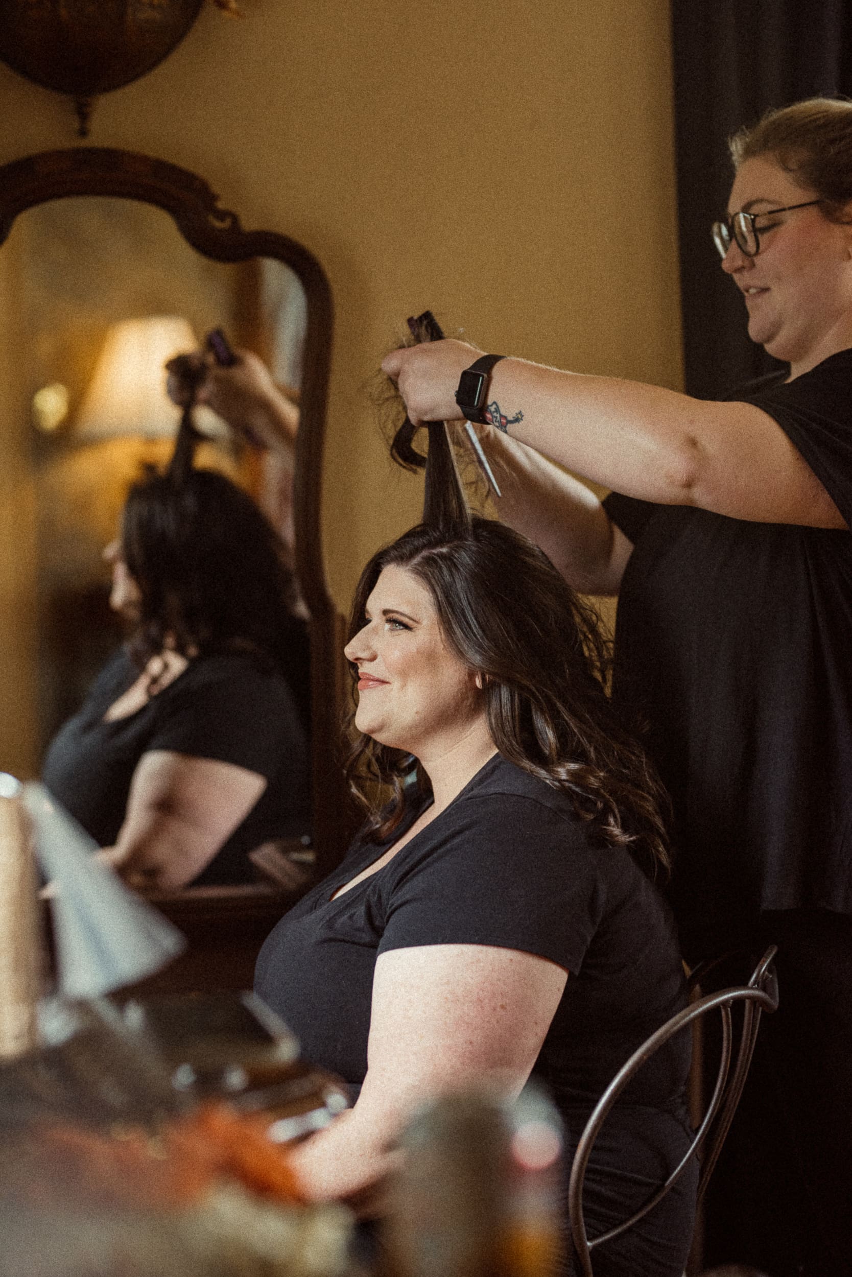 Bride having hair styled during getting ready moments of an intimate mountain wedding. 