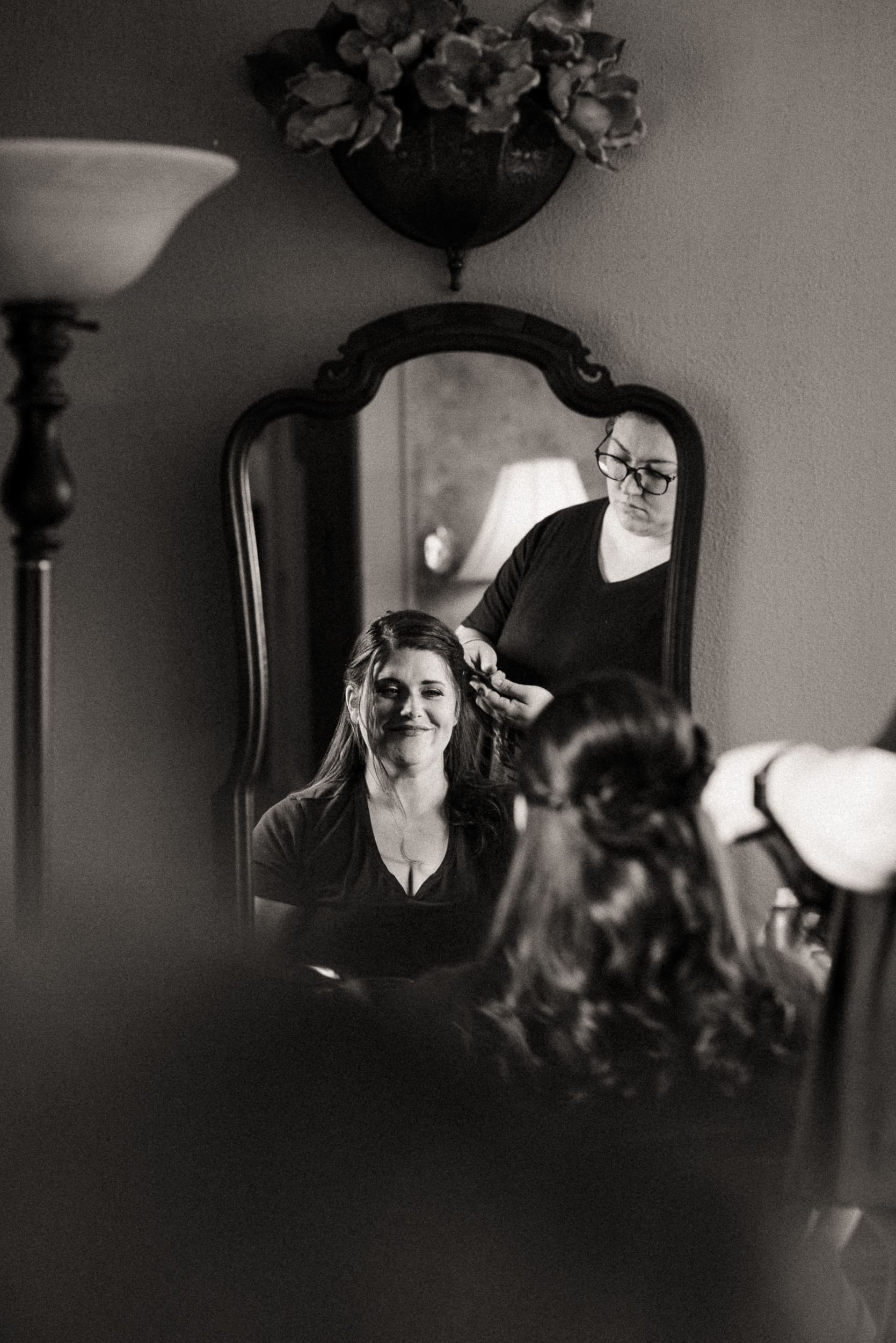 Bride getting her hair done during an intimate mountain wedding morning in North Carolina