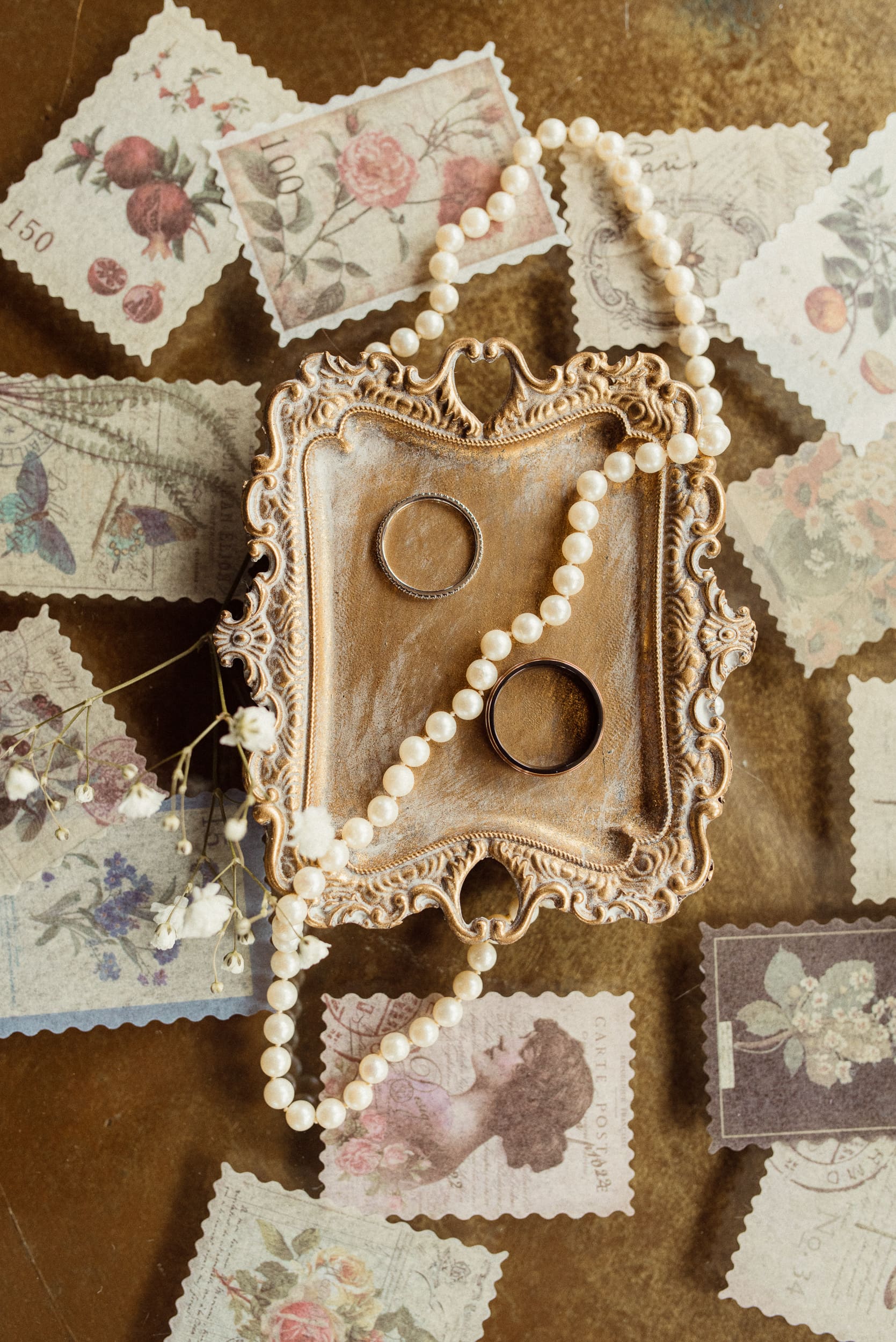 Wedding rings and vintage details styled together for an intimate wedding flatlay. 