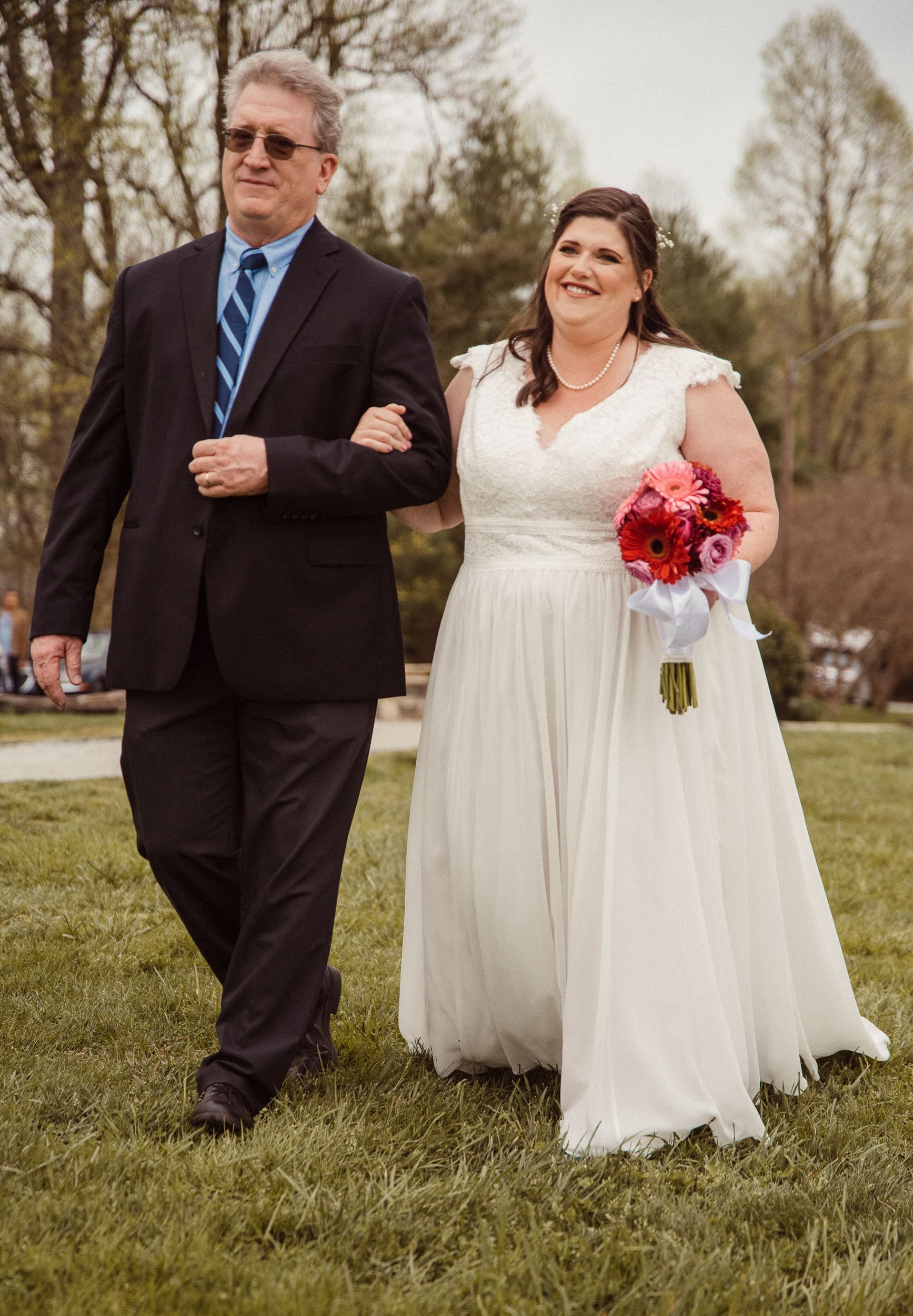 Bride walking down the aisle with her father during intimate mountain wedding ceremony