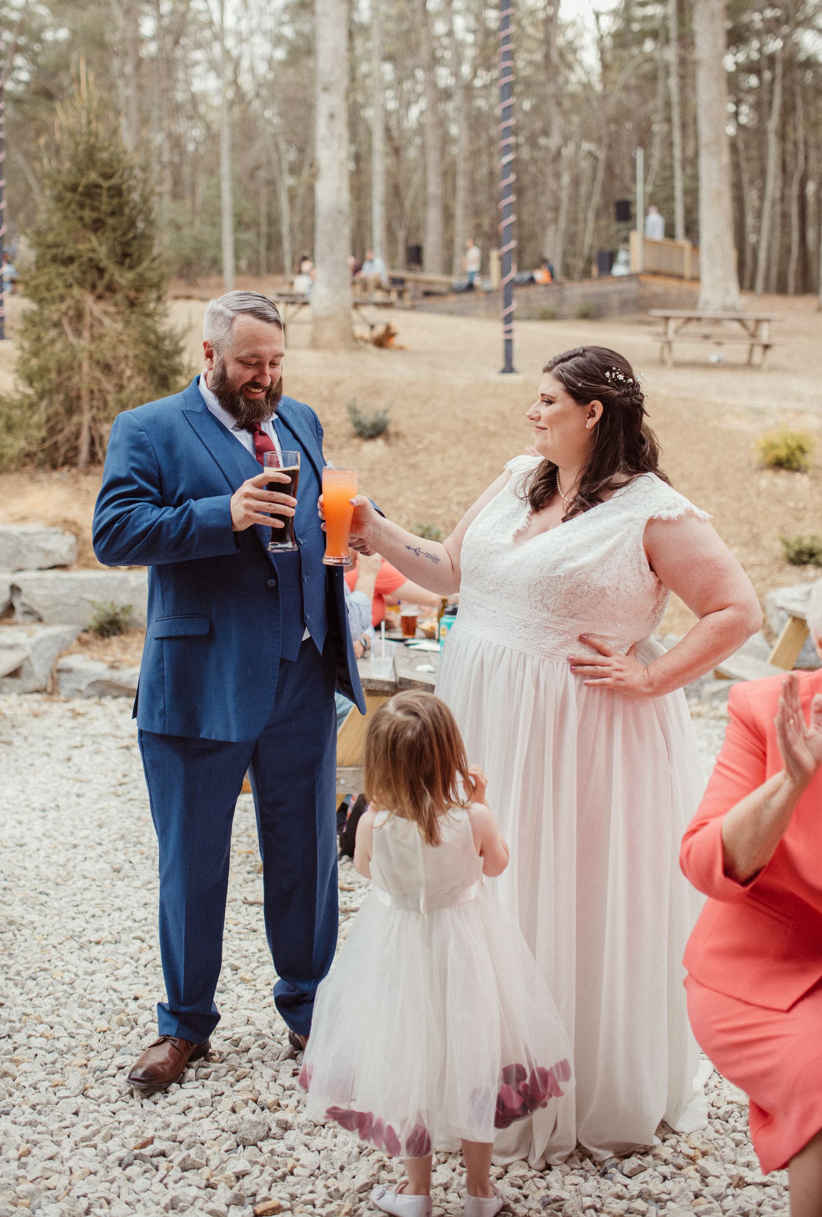 Bride and groom toasting drinks during a relaxed brewery celebration after their intimate North Carolina wedding.