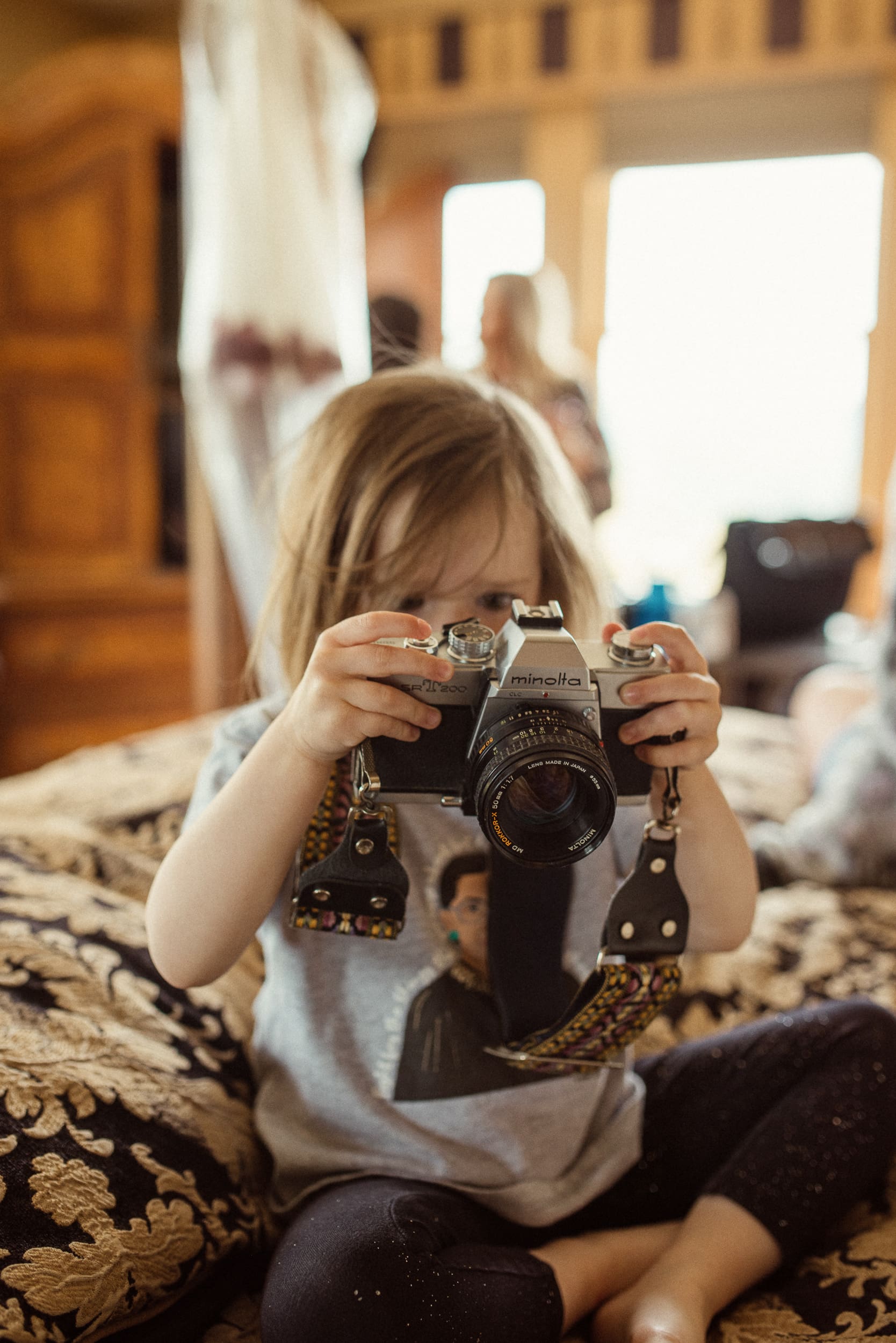 Child holding camera during candid moment at an intimate North Carolina wedding. 