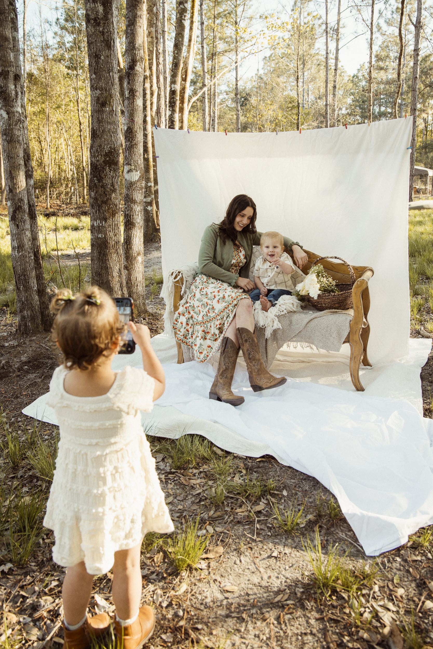 Backyard family session during golden hour with soft sunset light through trees.
