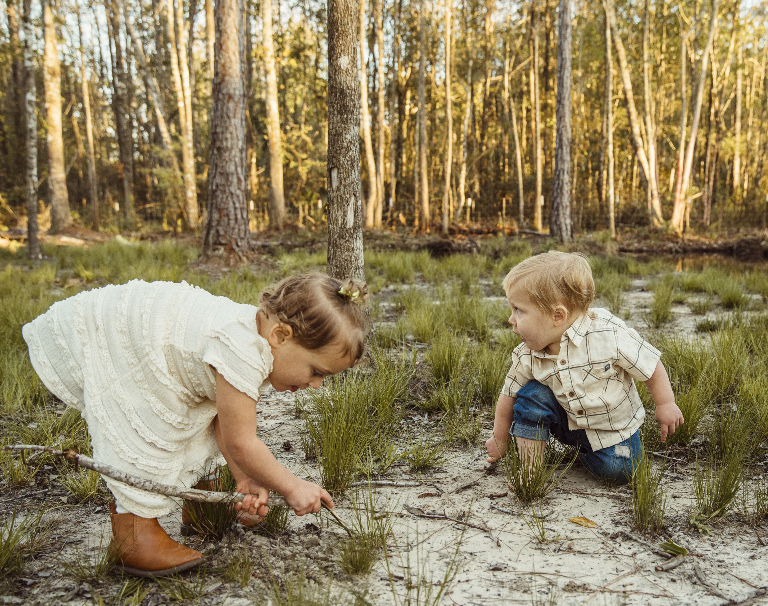 child hosting a pretend tea party with sand during a backyard family session