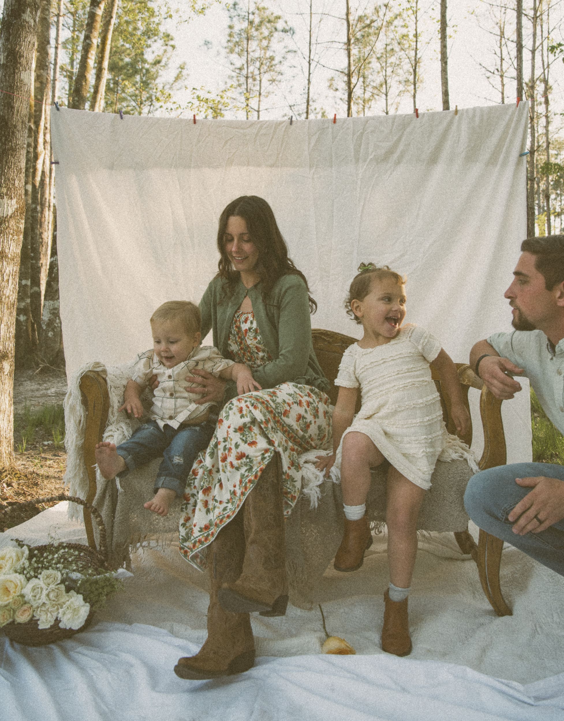 young kids laughing and playing outside during a family photo session