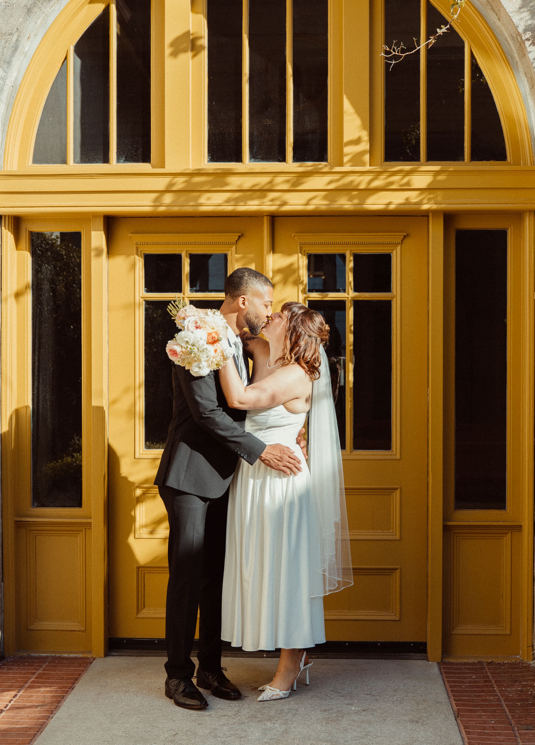 Romantic elopement portrait of couple kissing at the Lightner Museum in St Augustine Florida.