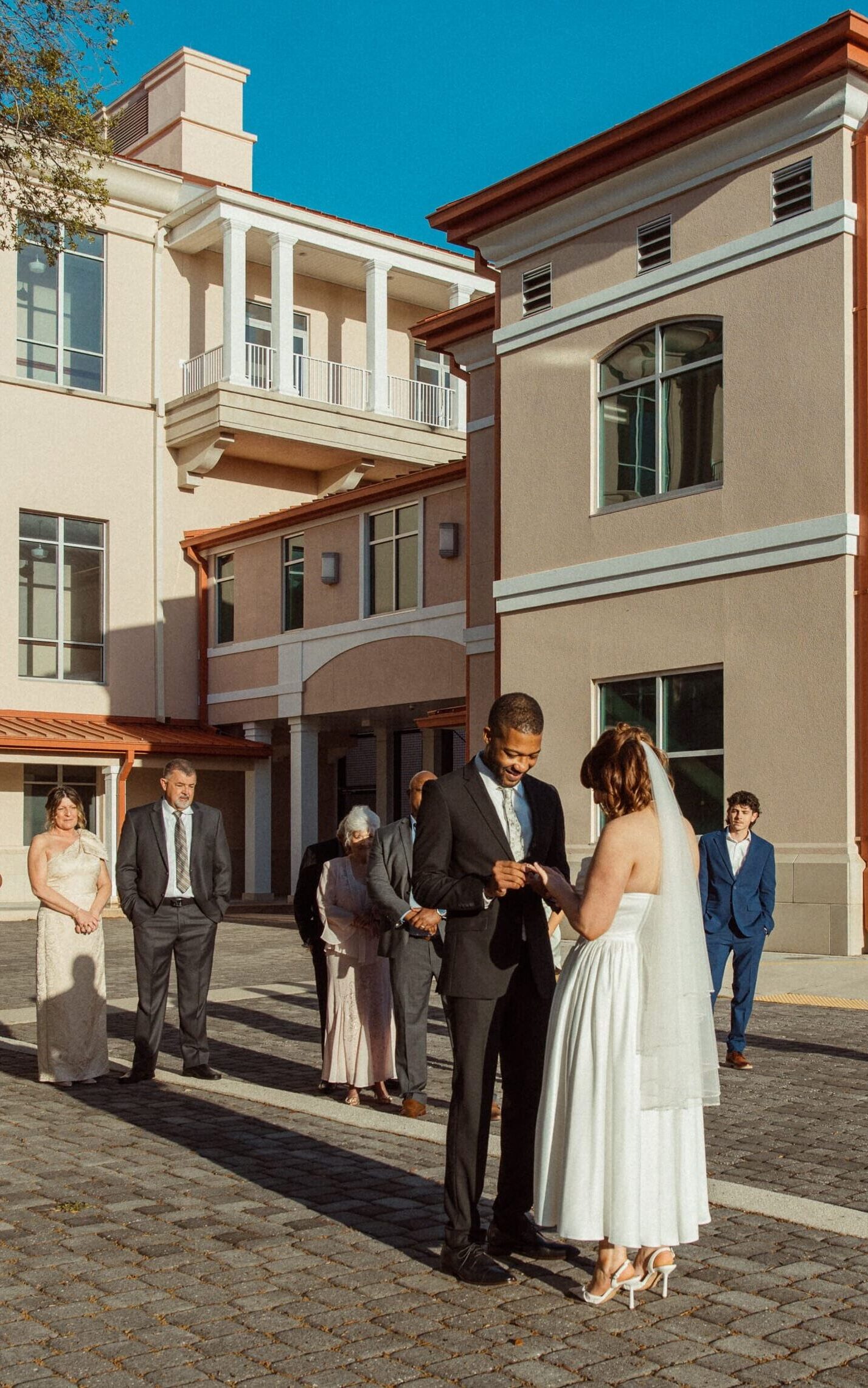 Small courthouse wedding ceremony with family outside St. Augustine courthouse in Florida. 