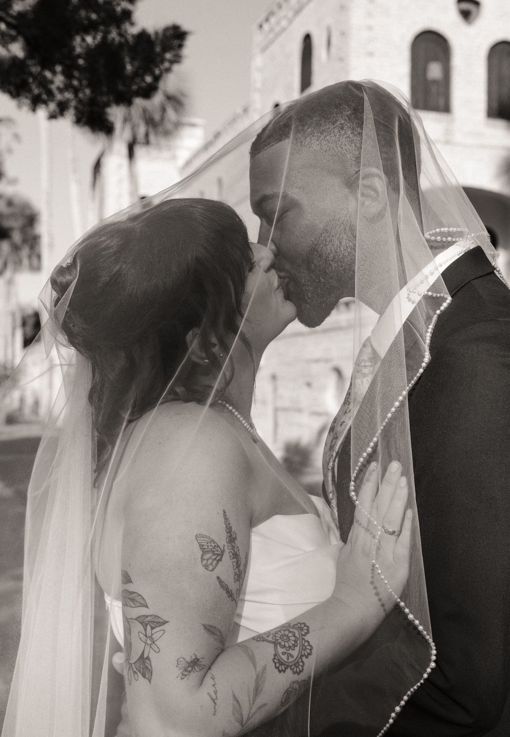 Black and white veil portrait of couple during Lightner Museum elopement in St Augustine. 