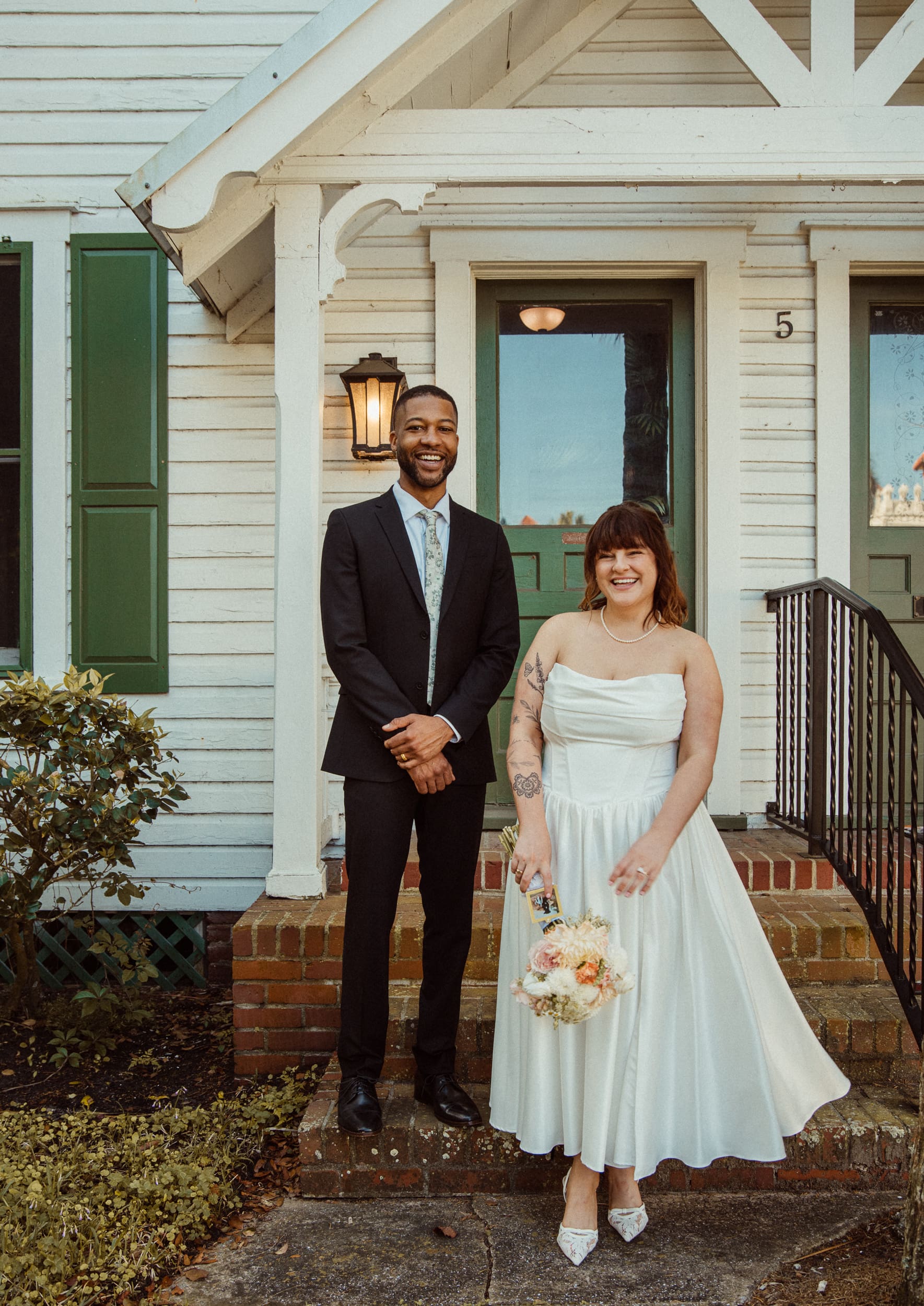 Couple posing in front of historic home near Lightner Museum after St Augustine elopement. 