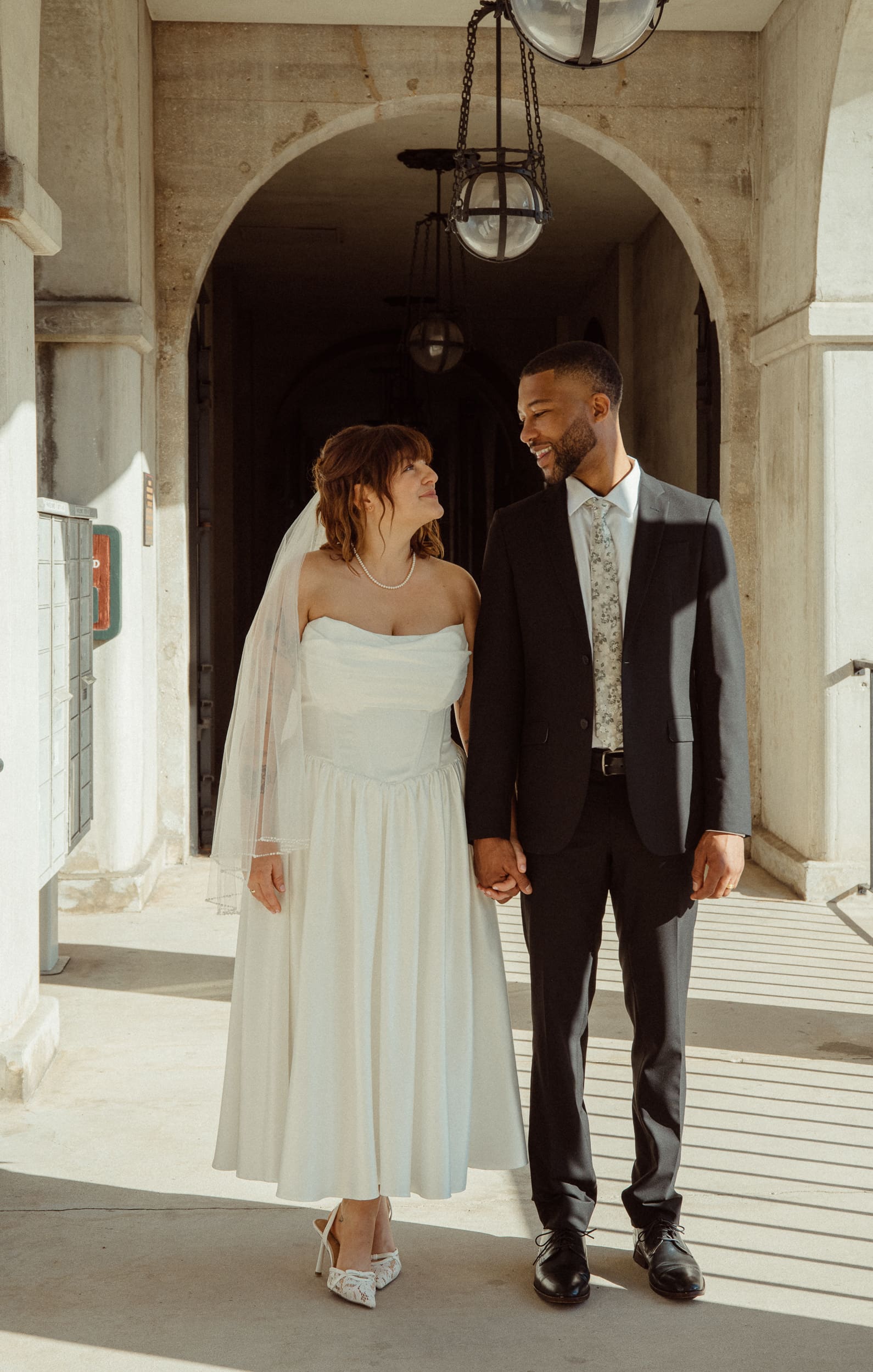 Couple standing under arches at Lightner Museum elopement in St Augustine. 