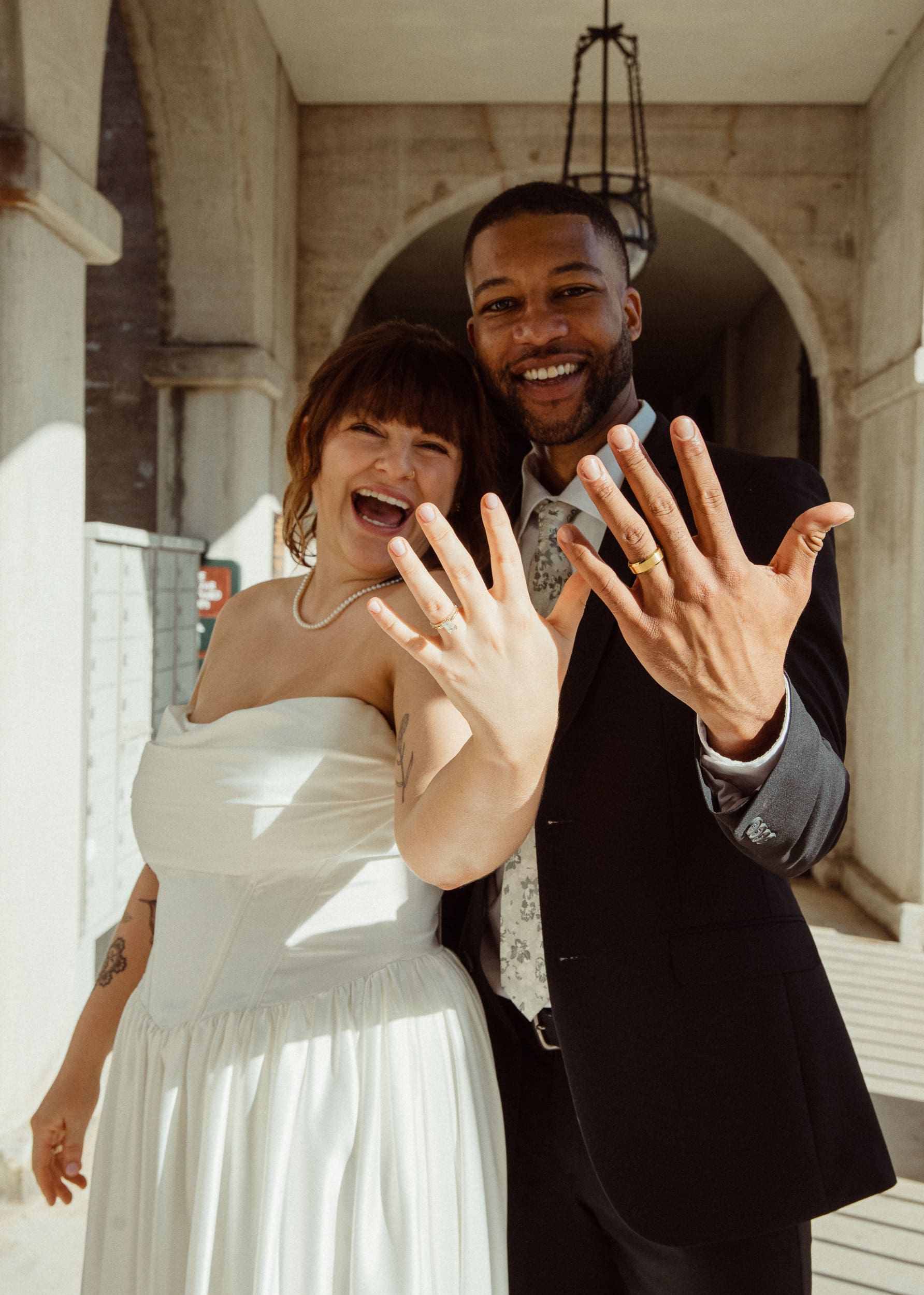 Newly married couple showing wedding rings after Lightner Museum elopement in St Augustine. 