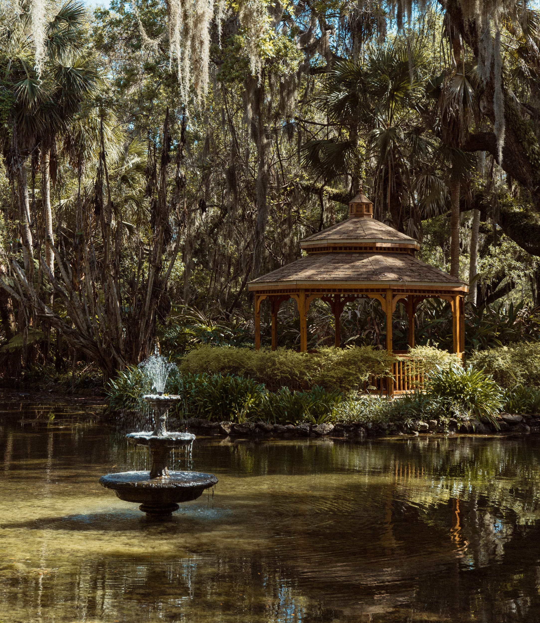 Gazebo and fountain surrounded by lush greenery at Washington Oaks Gardens State Park in Florida, a beautiful elopement location.