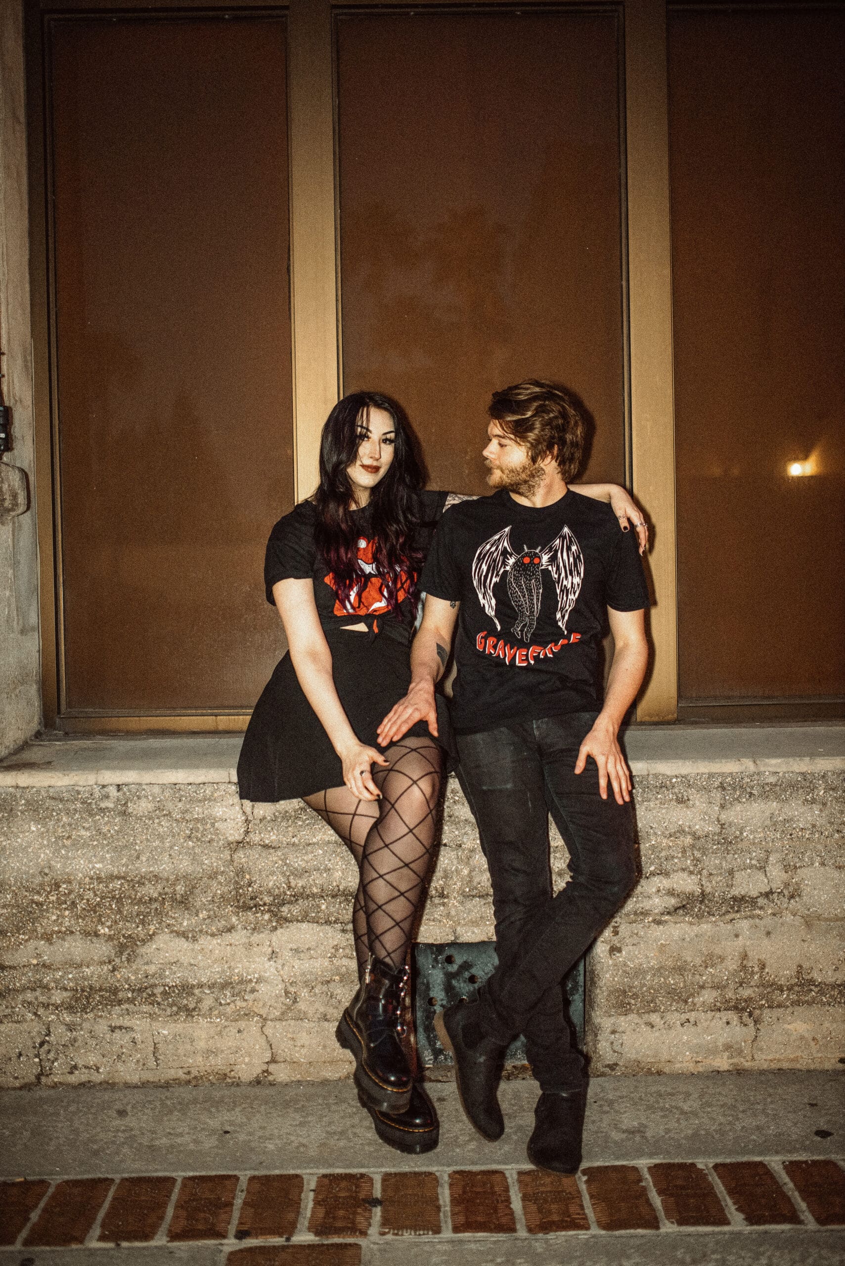 Couple in edgy outfits posing together during a bold and personality-driven engagement session