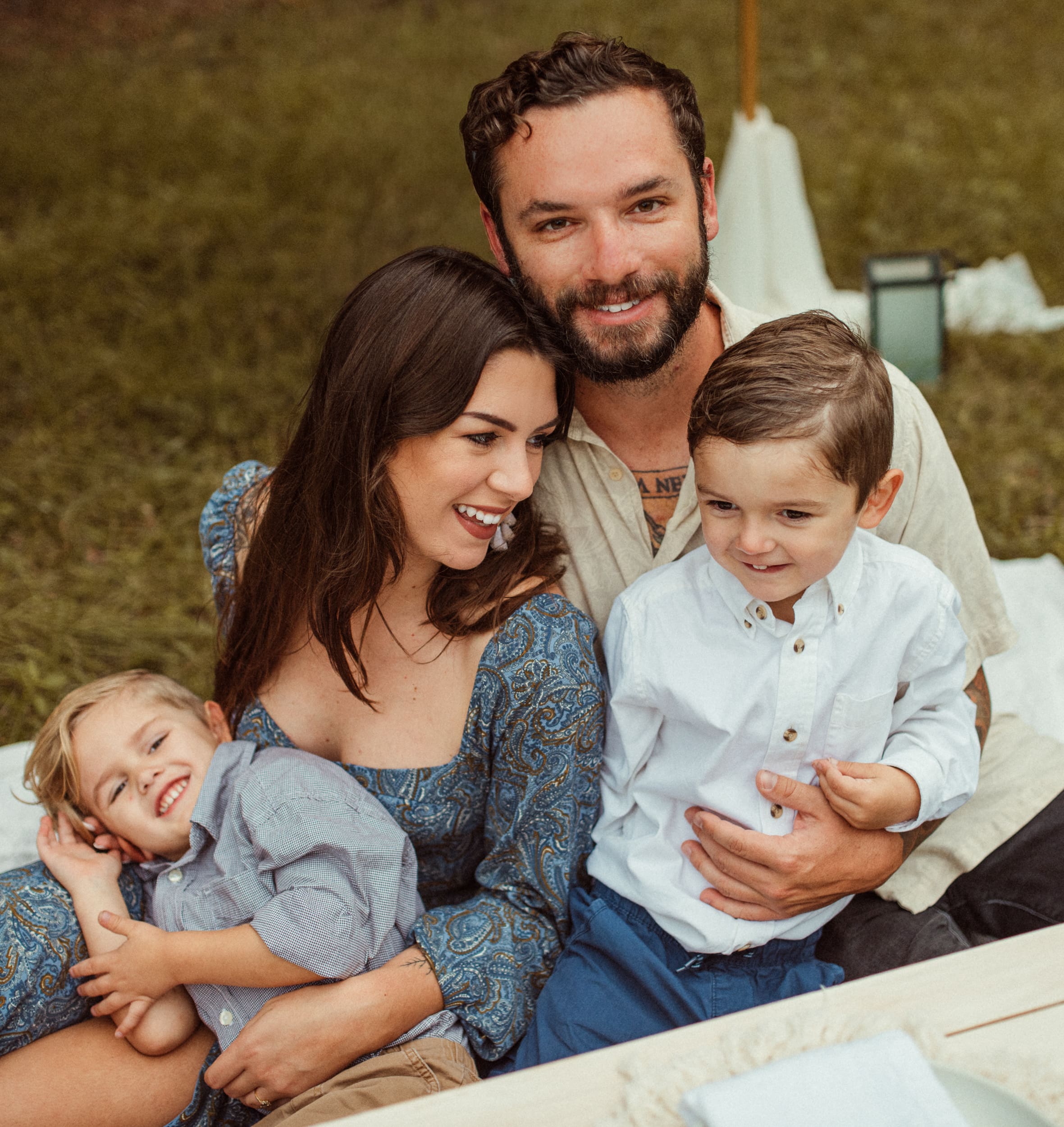 Couple with their two young children during a romantic backyard engagement session in Mandarin, Florida.