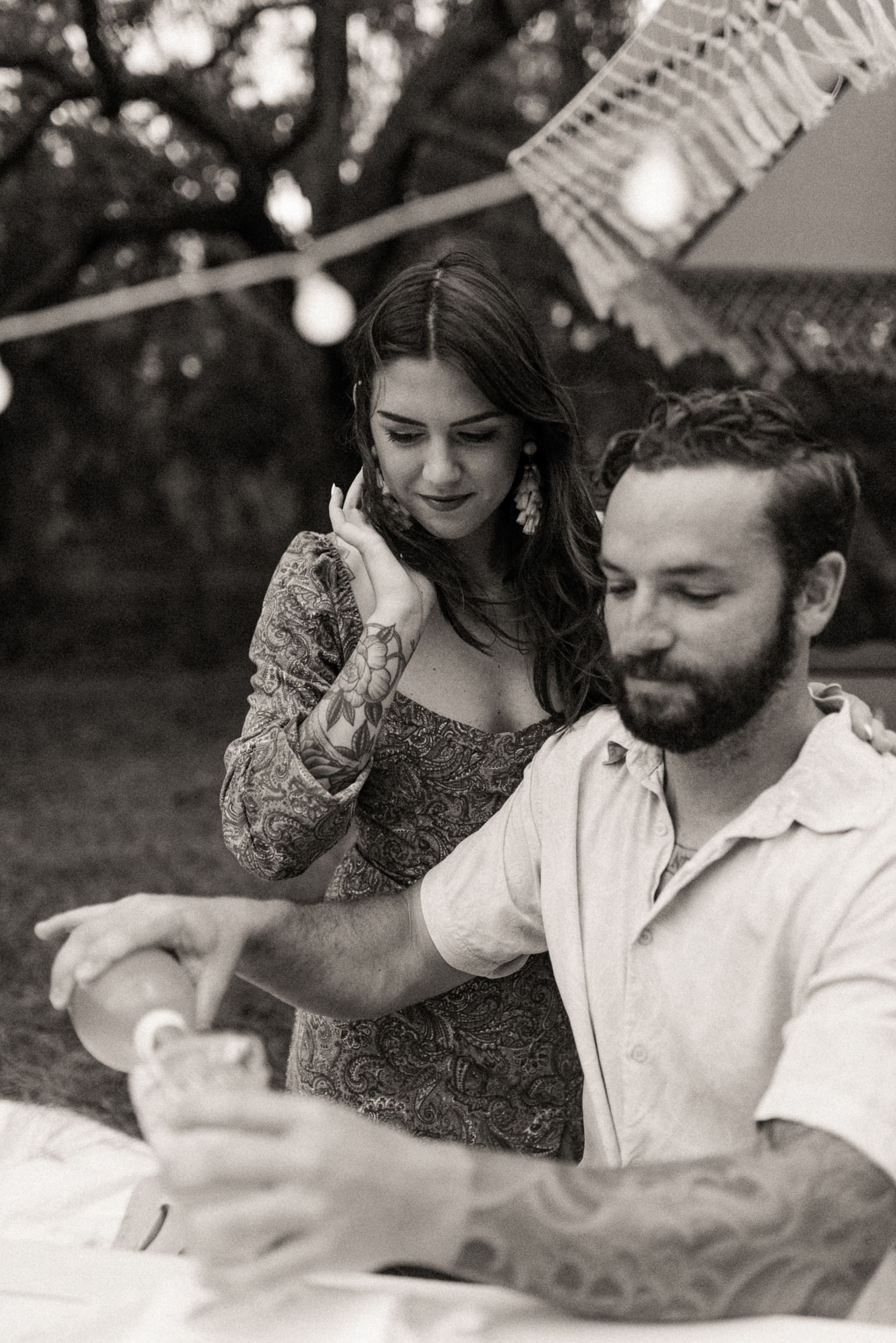 Black and white candid moment of a couple during an intimate backyard engagement session in Jacksonville, Florida.