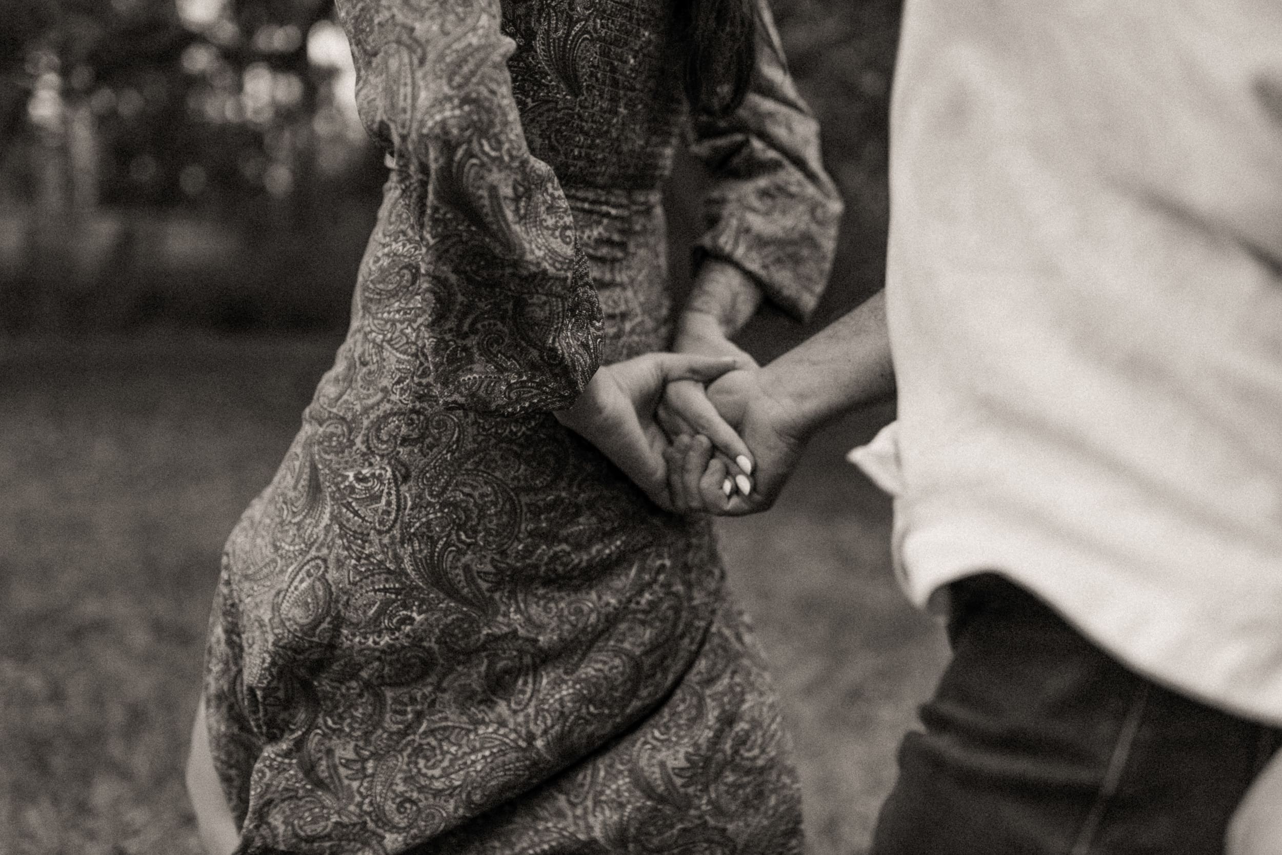 Close-up of a couple holding hands during an intimate backyard engagement session in Mandarin, Florida.